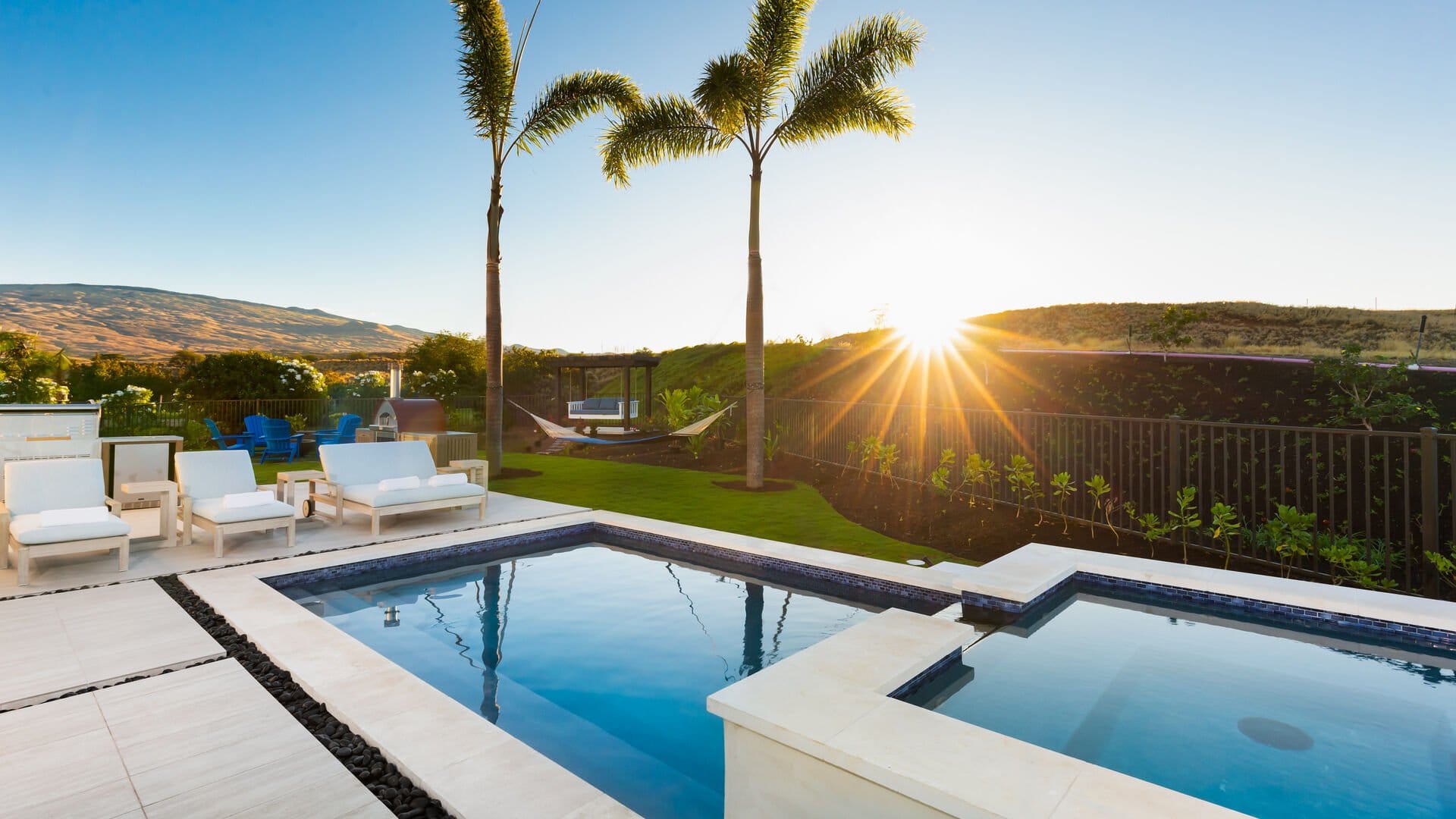 Luxurious backyard pool at sunset.