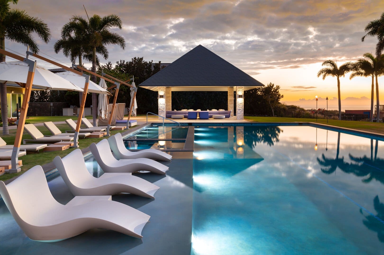 Luxurious poolside lounge at sunset.