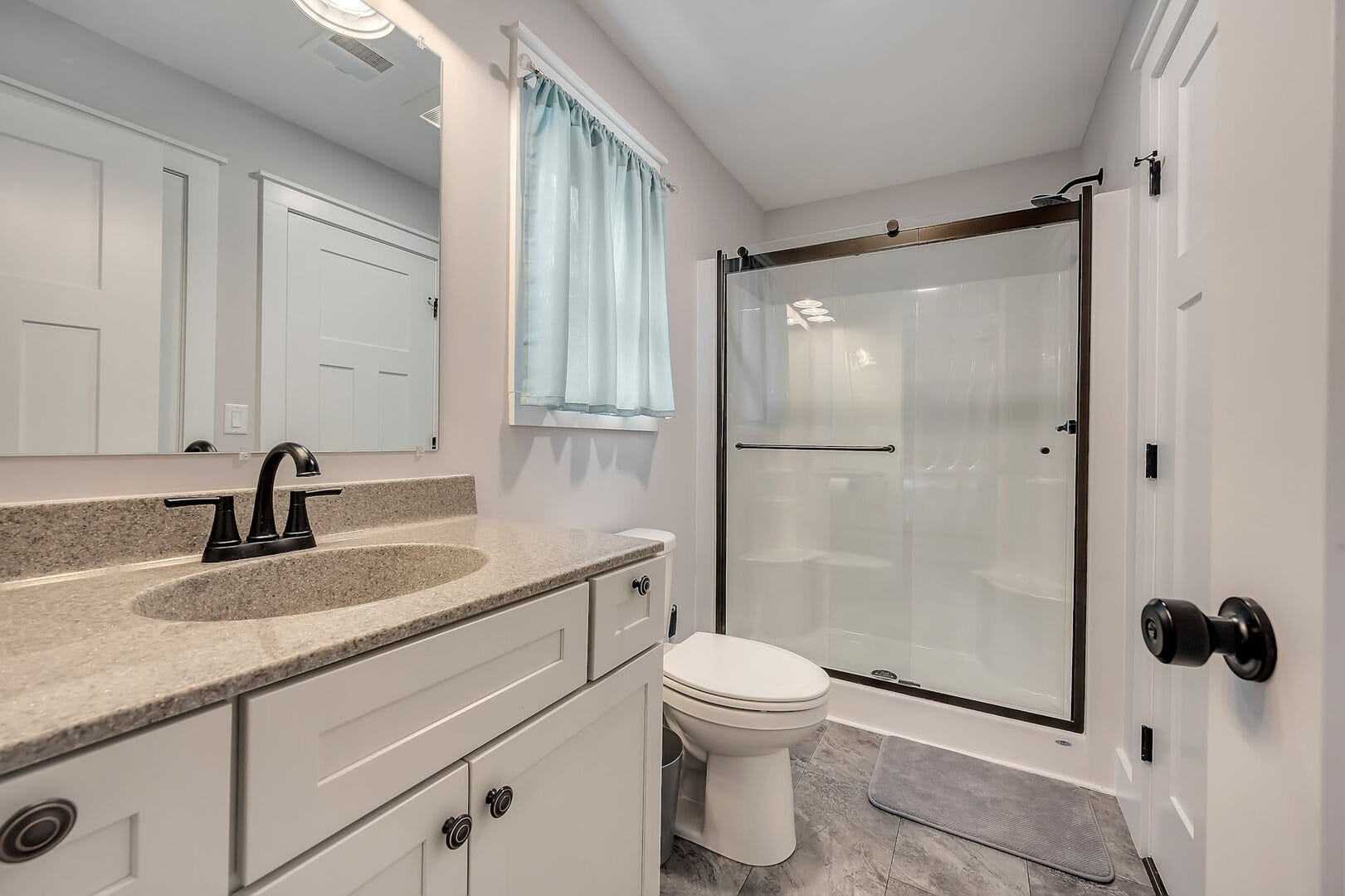 Modern bathroom with shower and vanity.