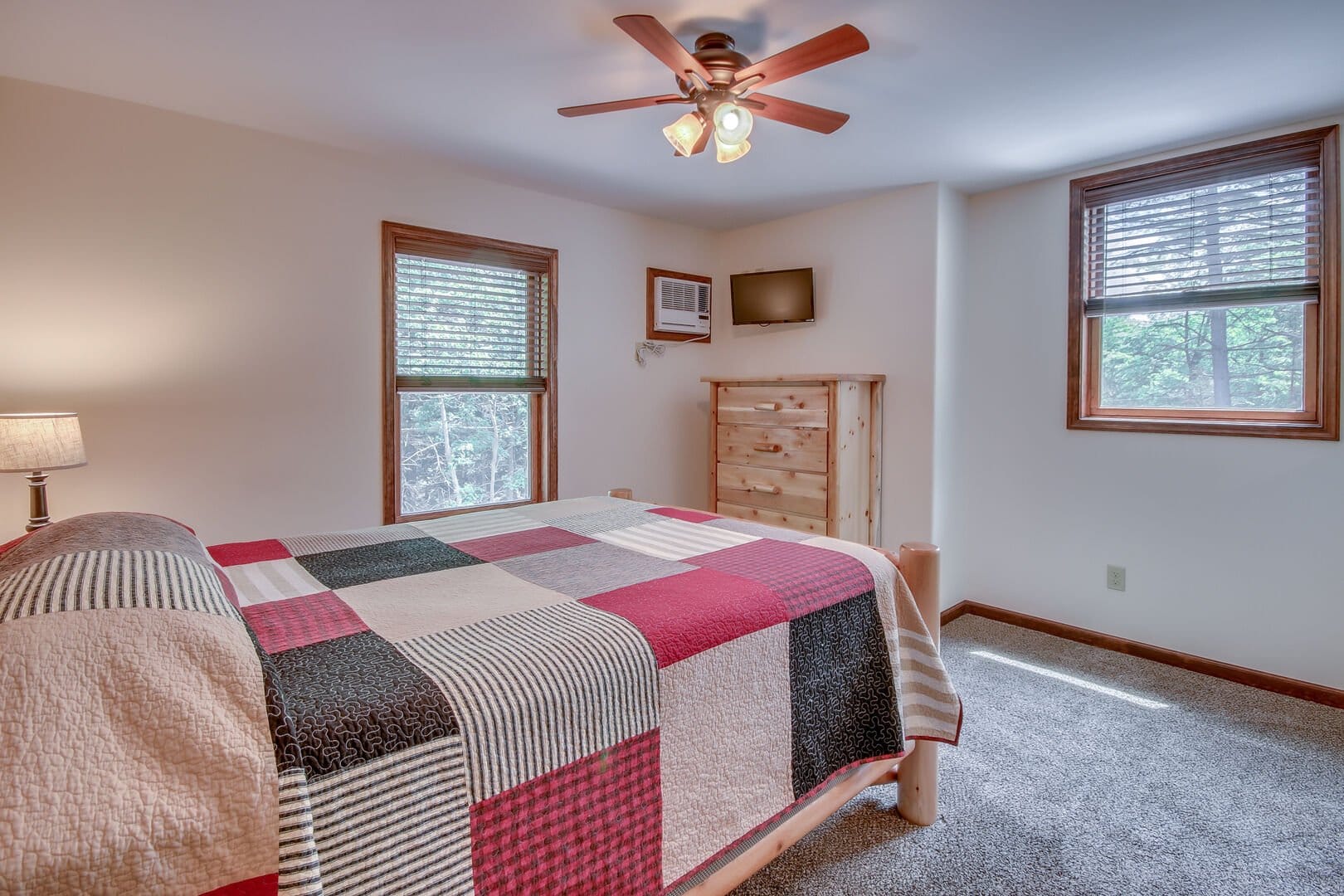 Cozy bedroom with ceiling fan.