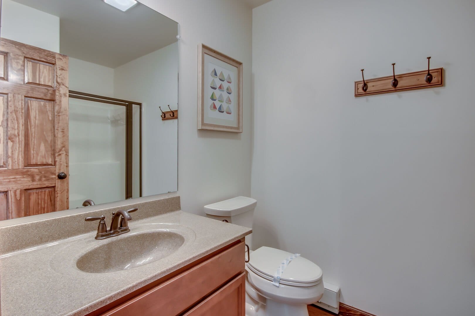 Clean bathroom with wooden accents.