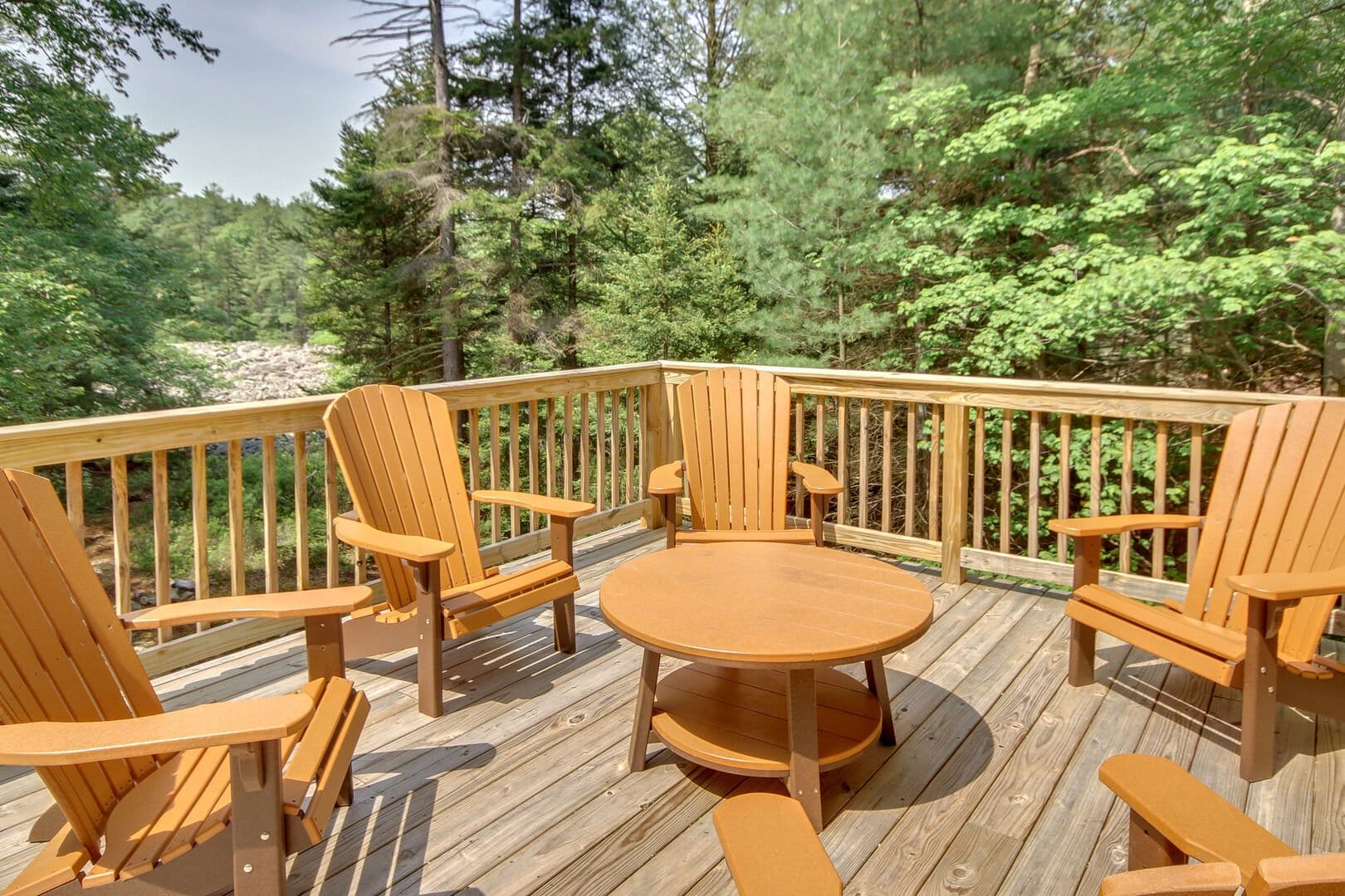 Wood deck with Adirondack chairs.