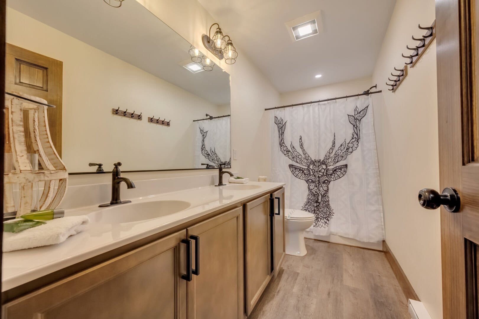 Bathroom with deer shower curtain.