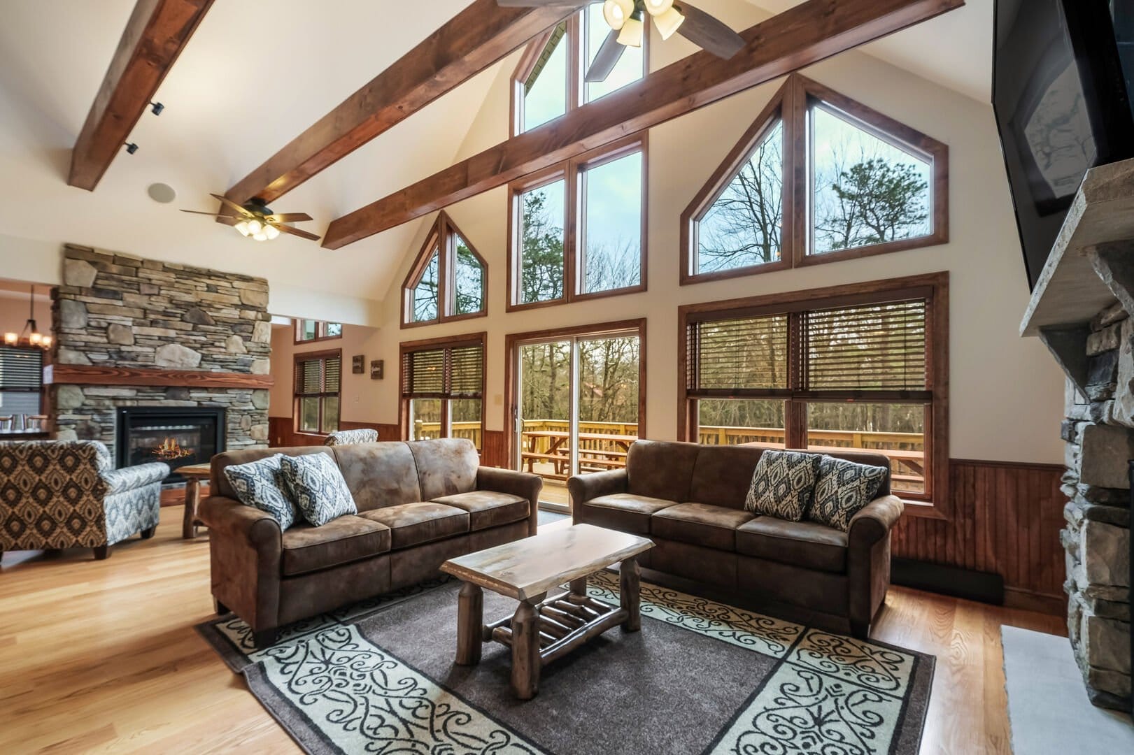 Rustic living room with large windows.