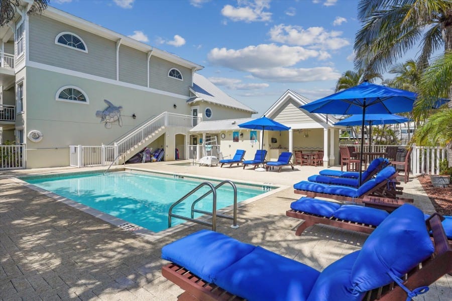 Outdoor pool with blue loungers.