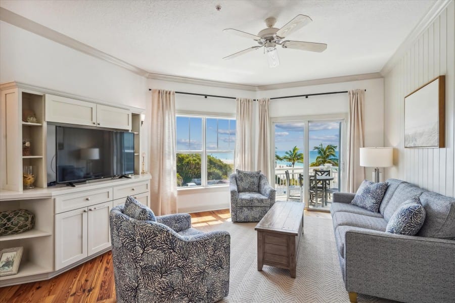 Beachfront living room with large windows.