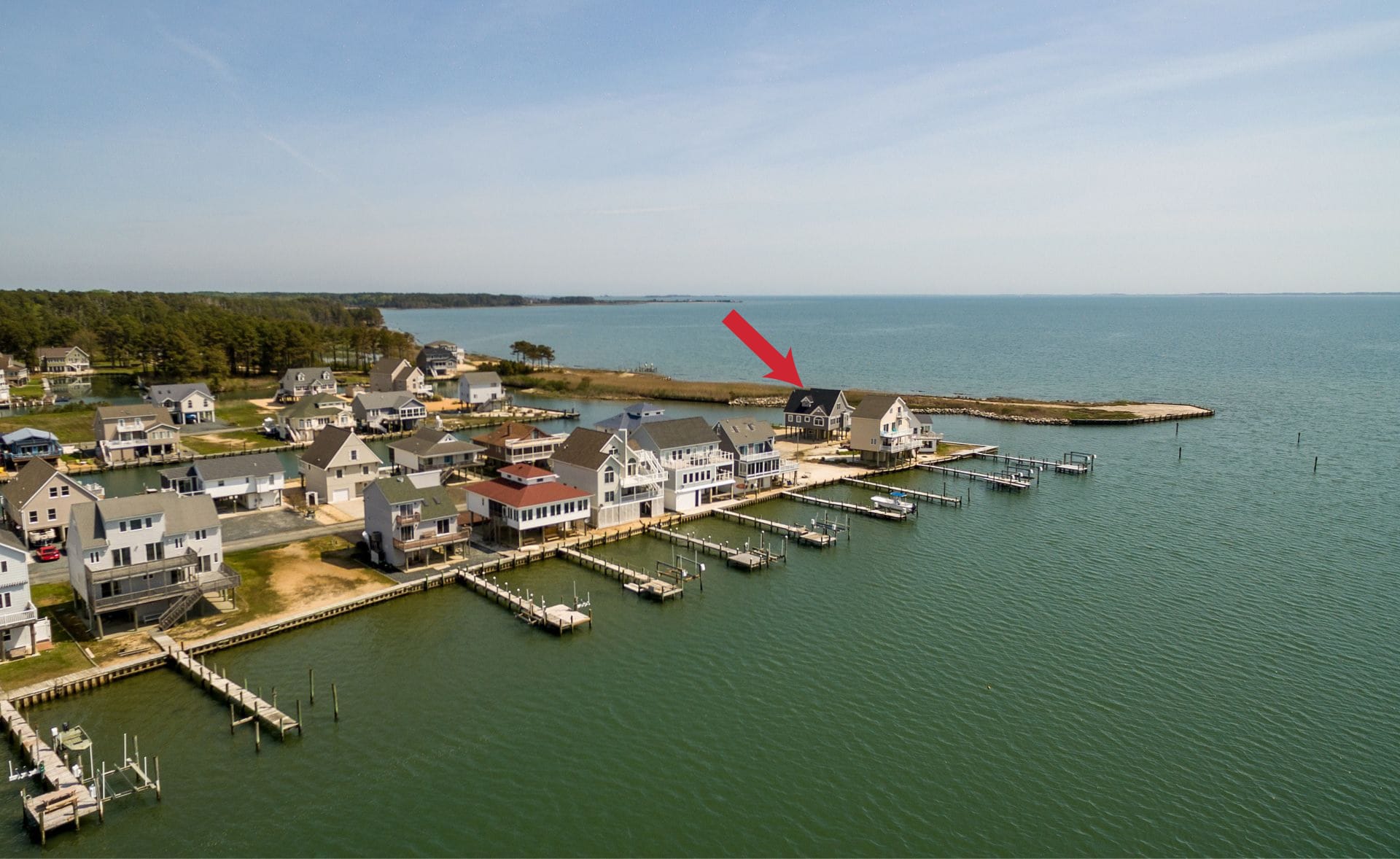 Coastal homes with docks, arrow pointing.