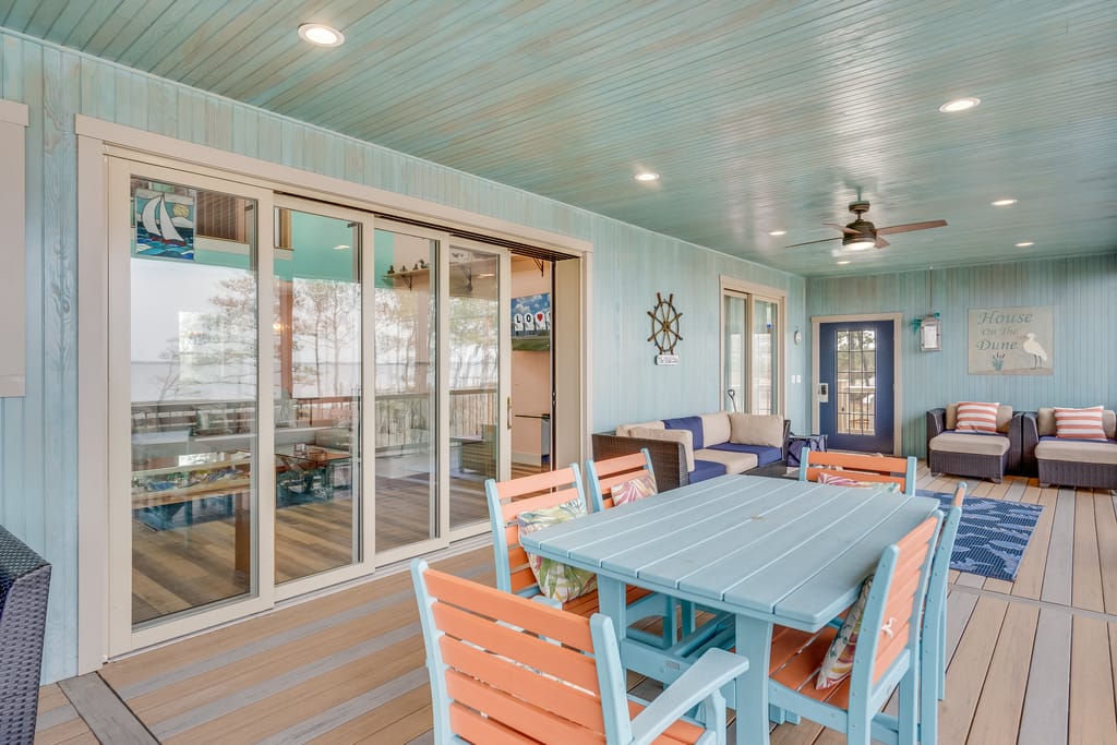 Cozy seaside porch with seating.