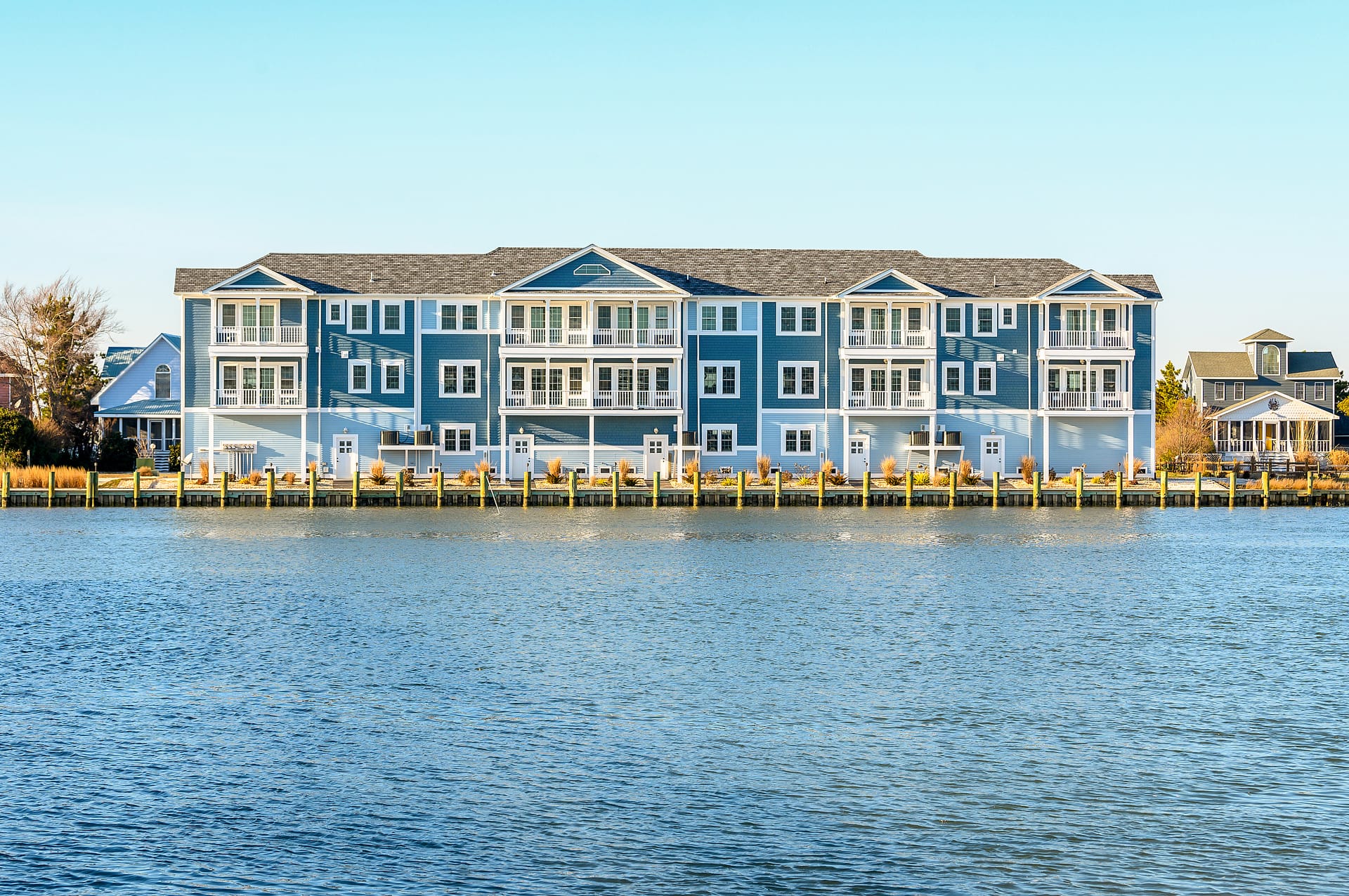 Waterfront blue apartment buildings shoreline.