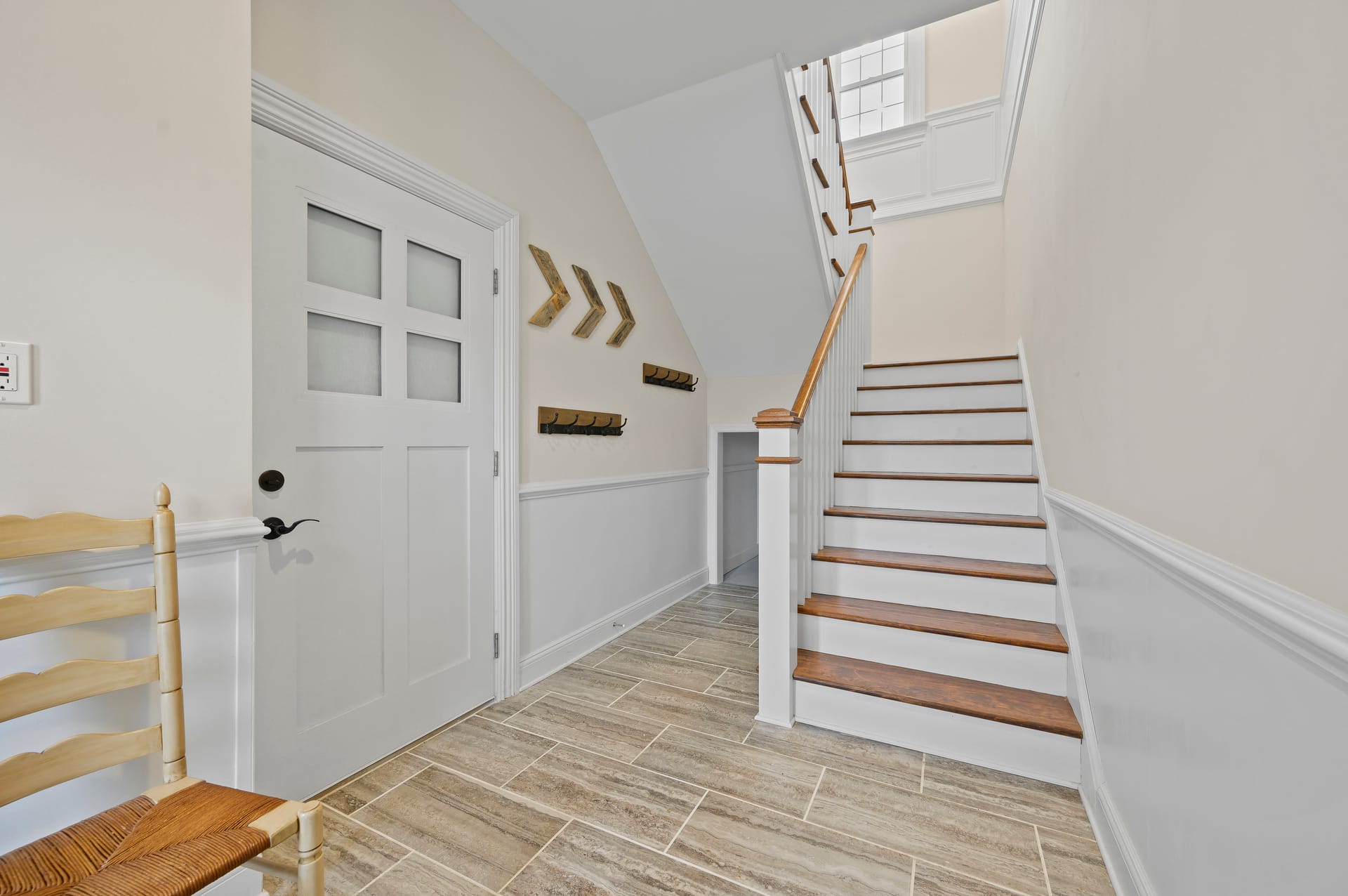 Hallway with staircase and door.