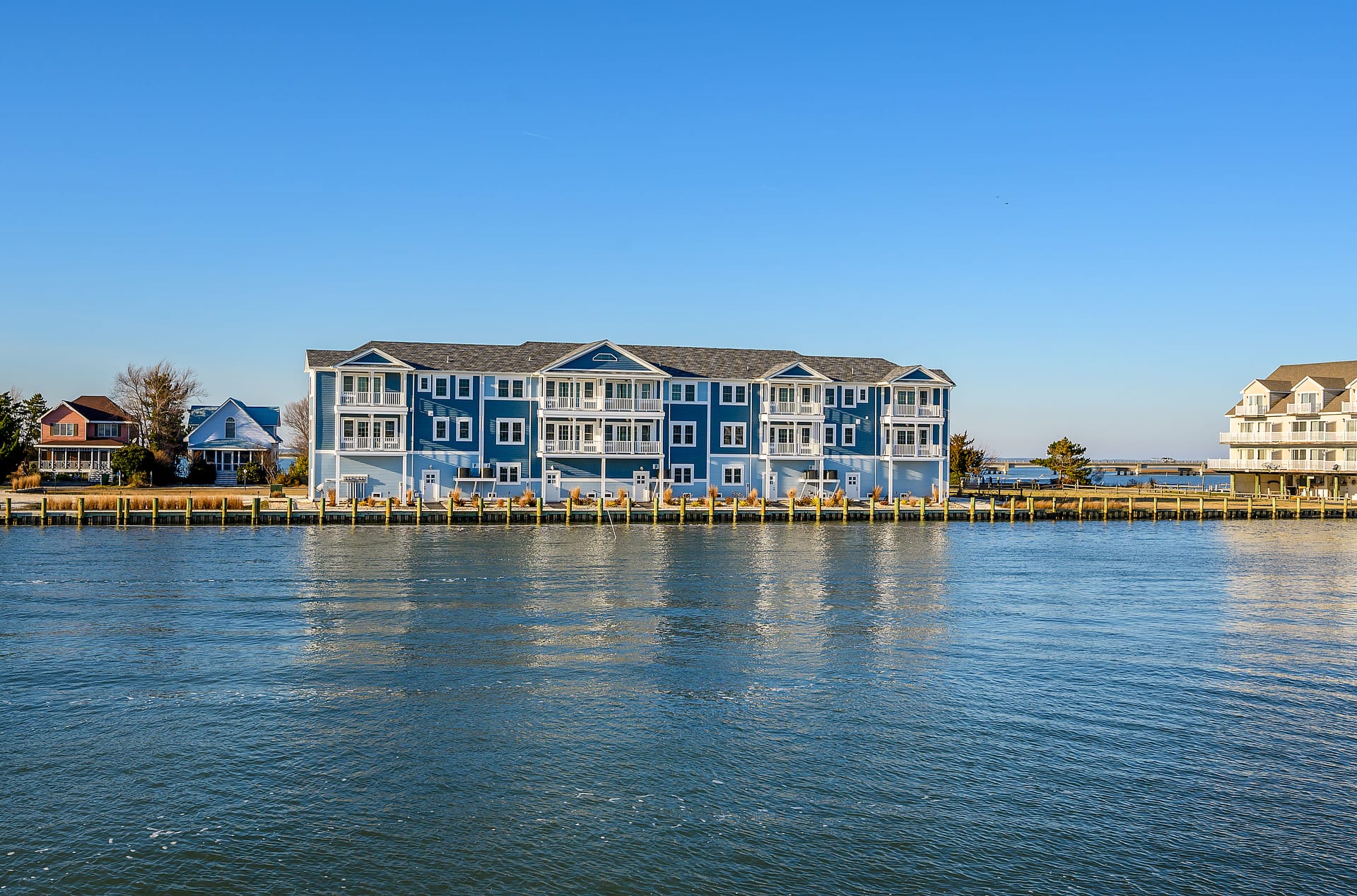 Waterside buildings under clear sky.