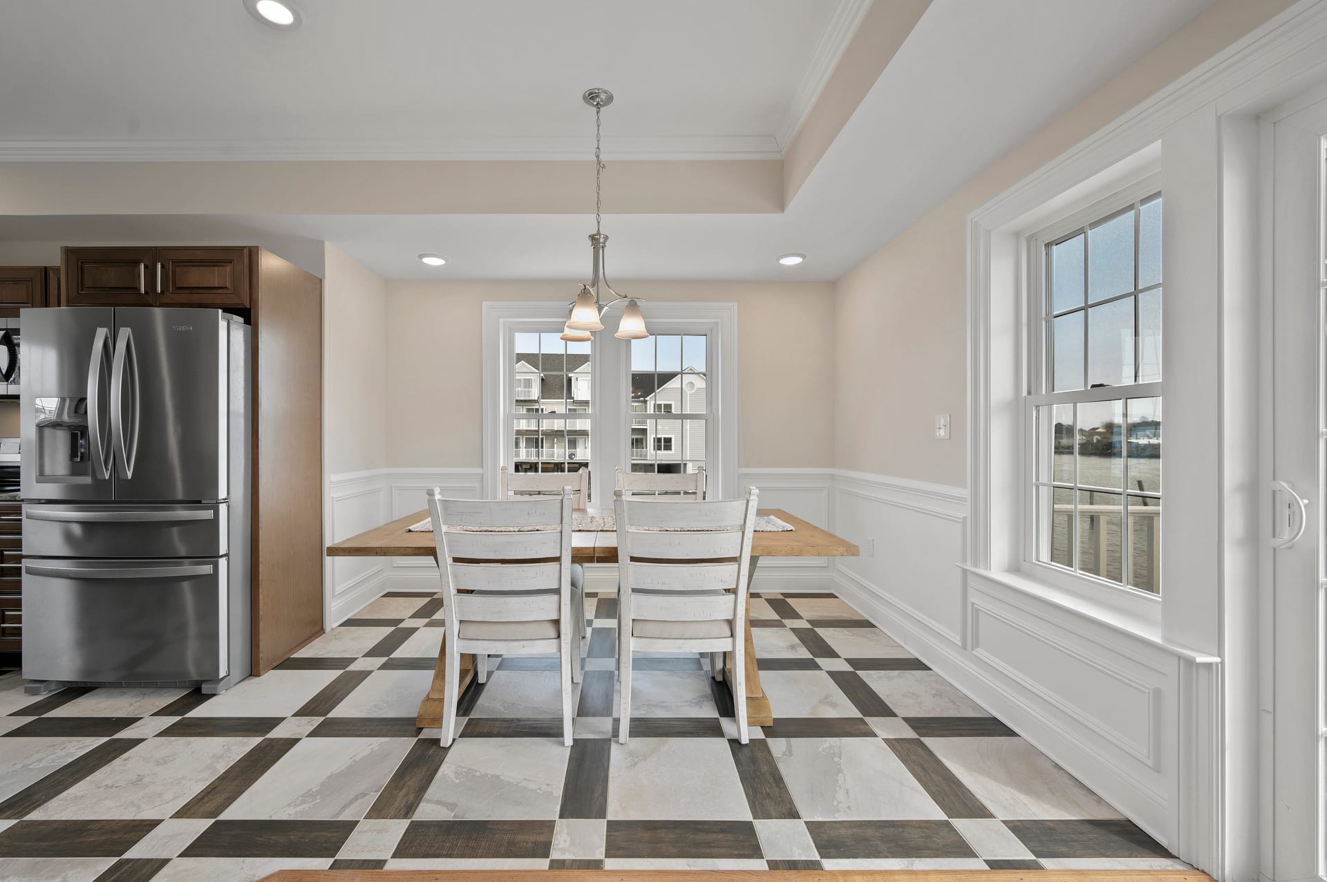 Modern kitchen dining area, table, windows.