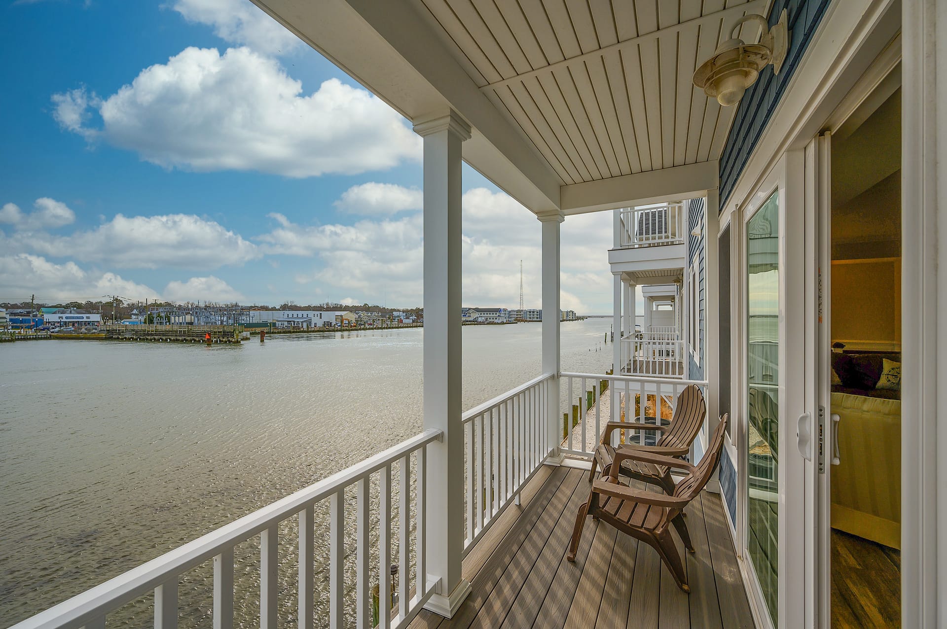 Waterfront balcony with chairs, view.