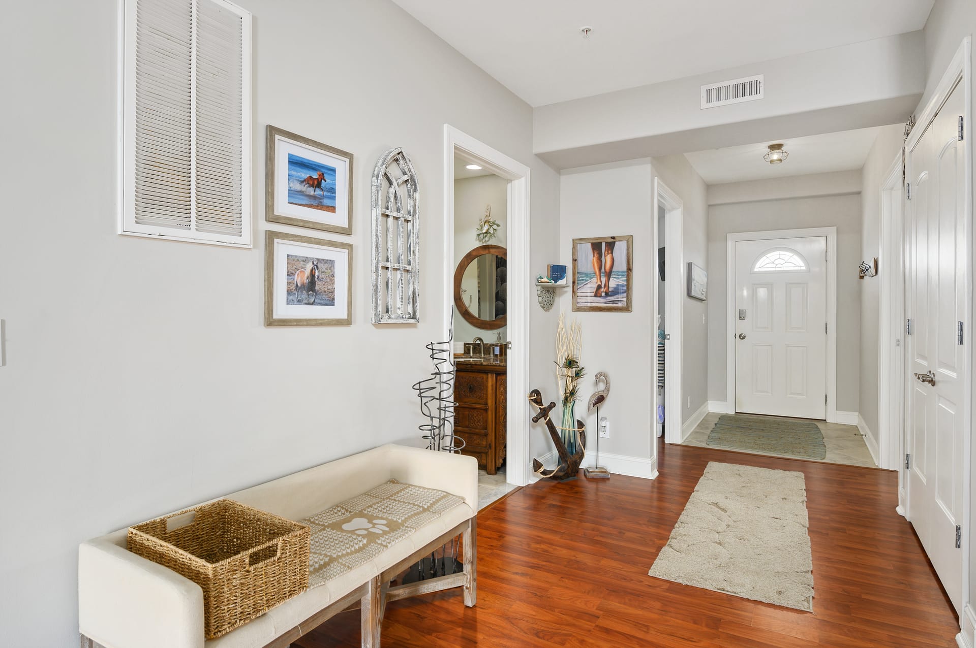 Hallway with decor and bench.