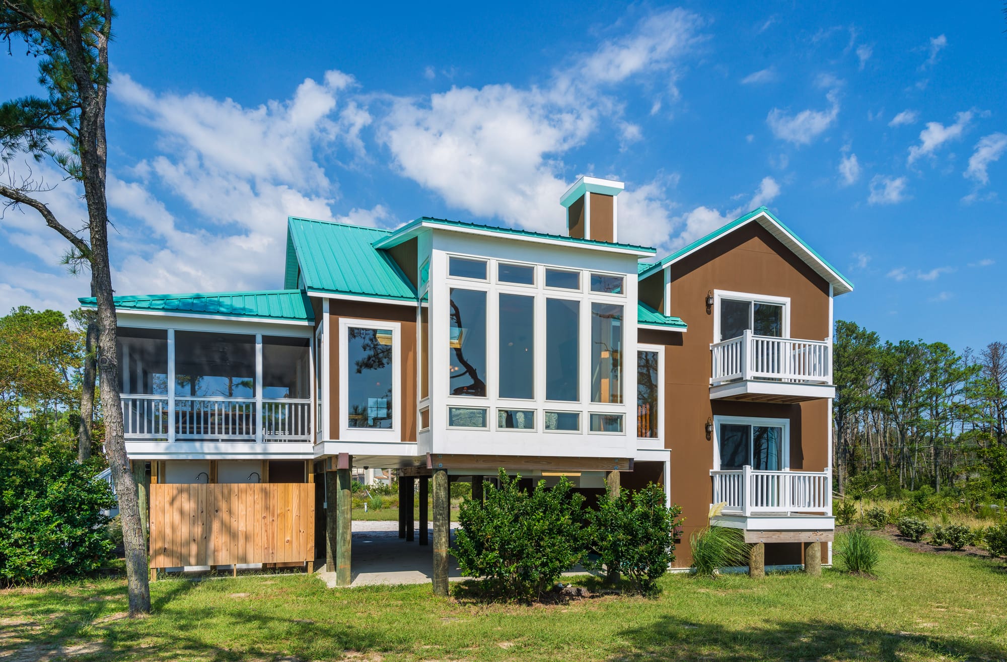 Elevated house with teal roof.