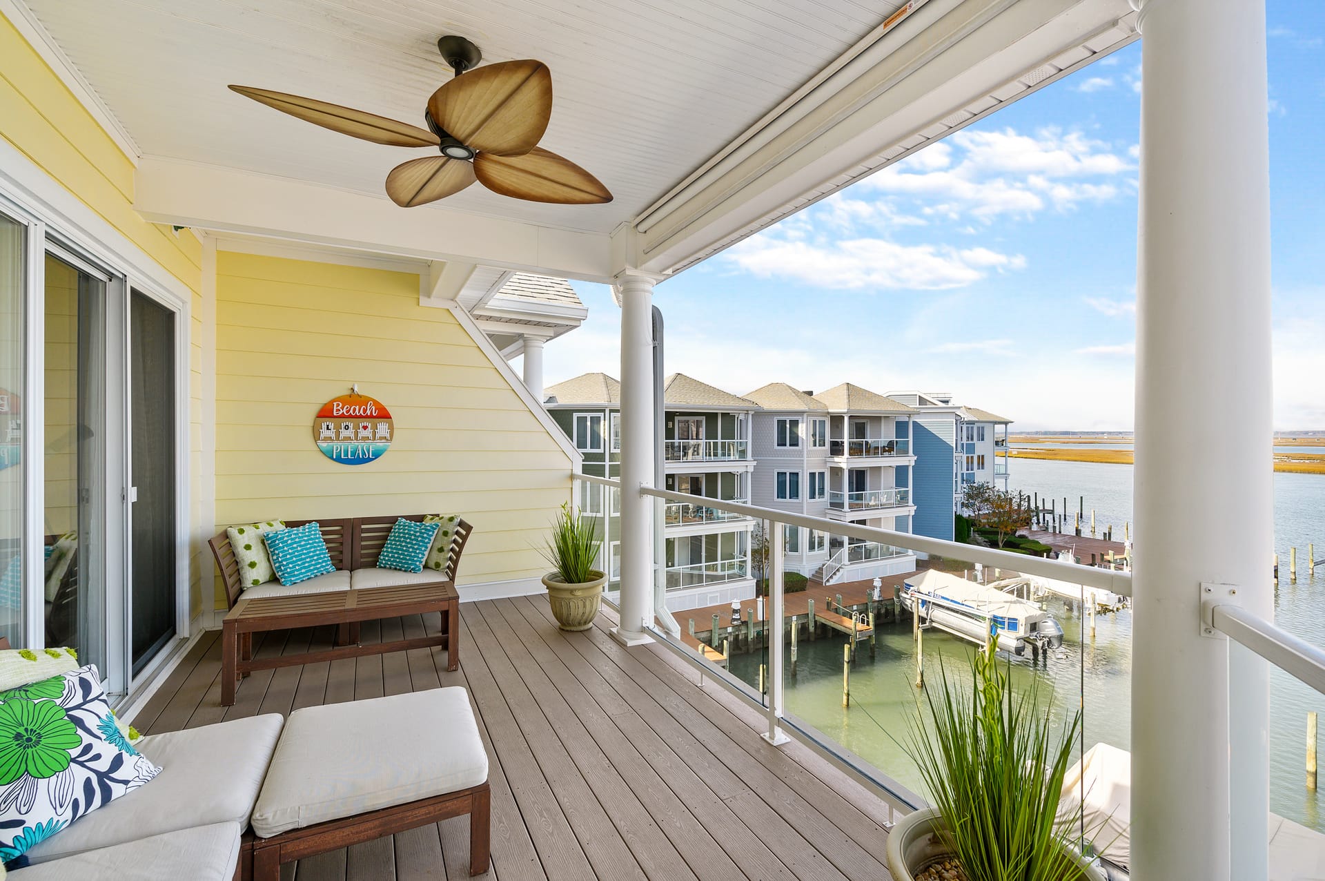 Balcony with waterfront view, seating.