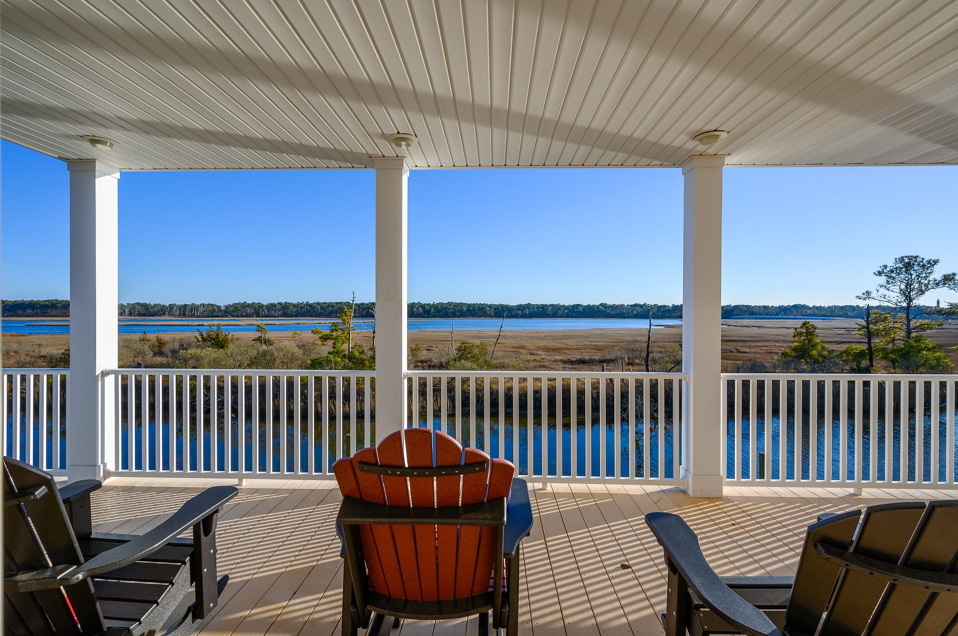 Chairs on patio facing water.