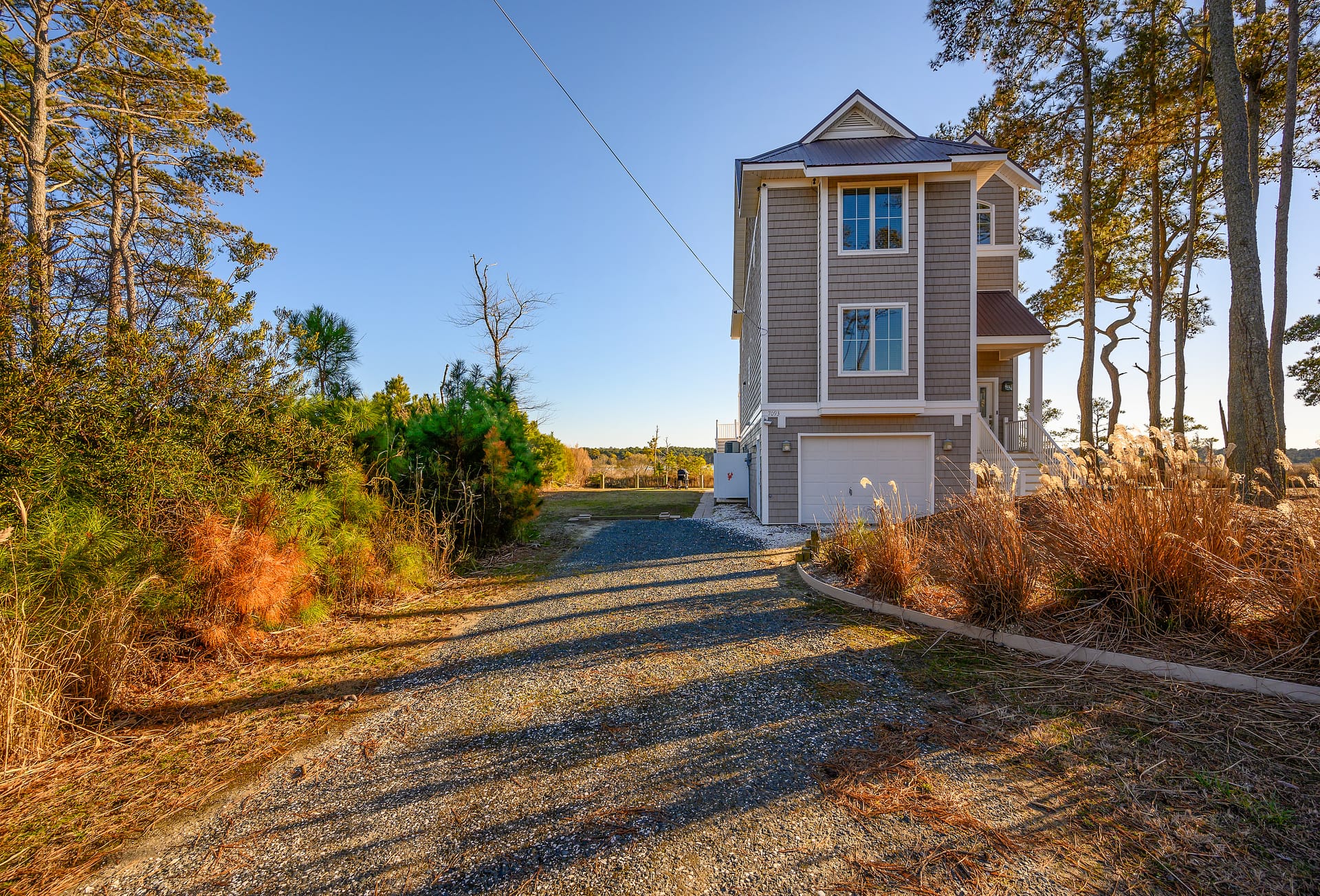 Two-story house with gravel driveway