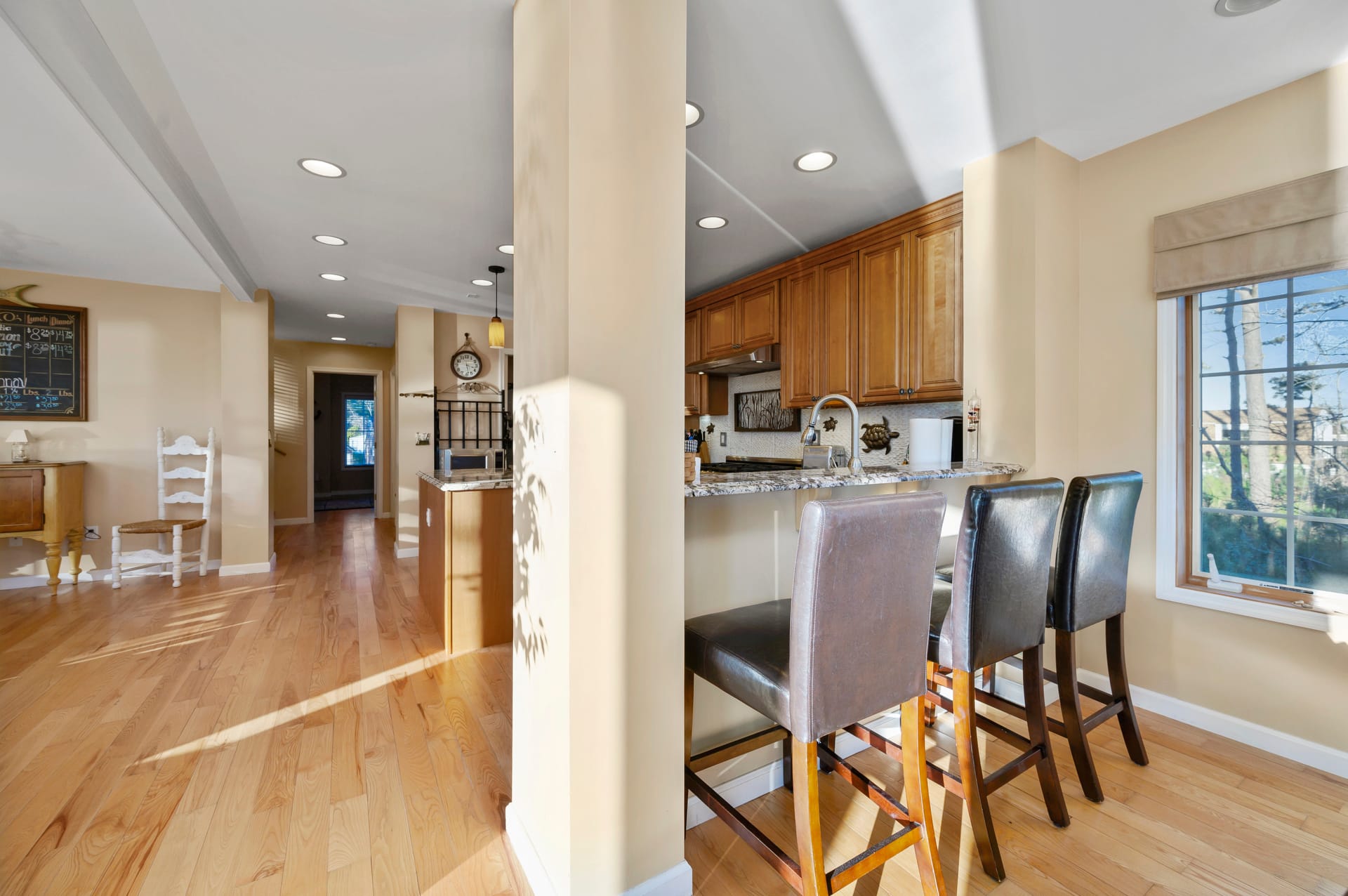 Open kitchen with bar stools.