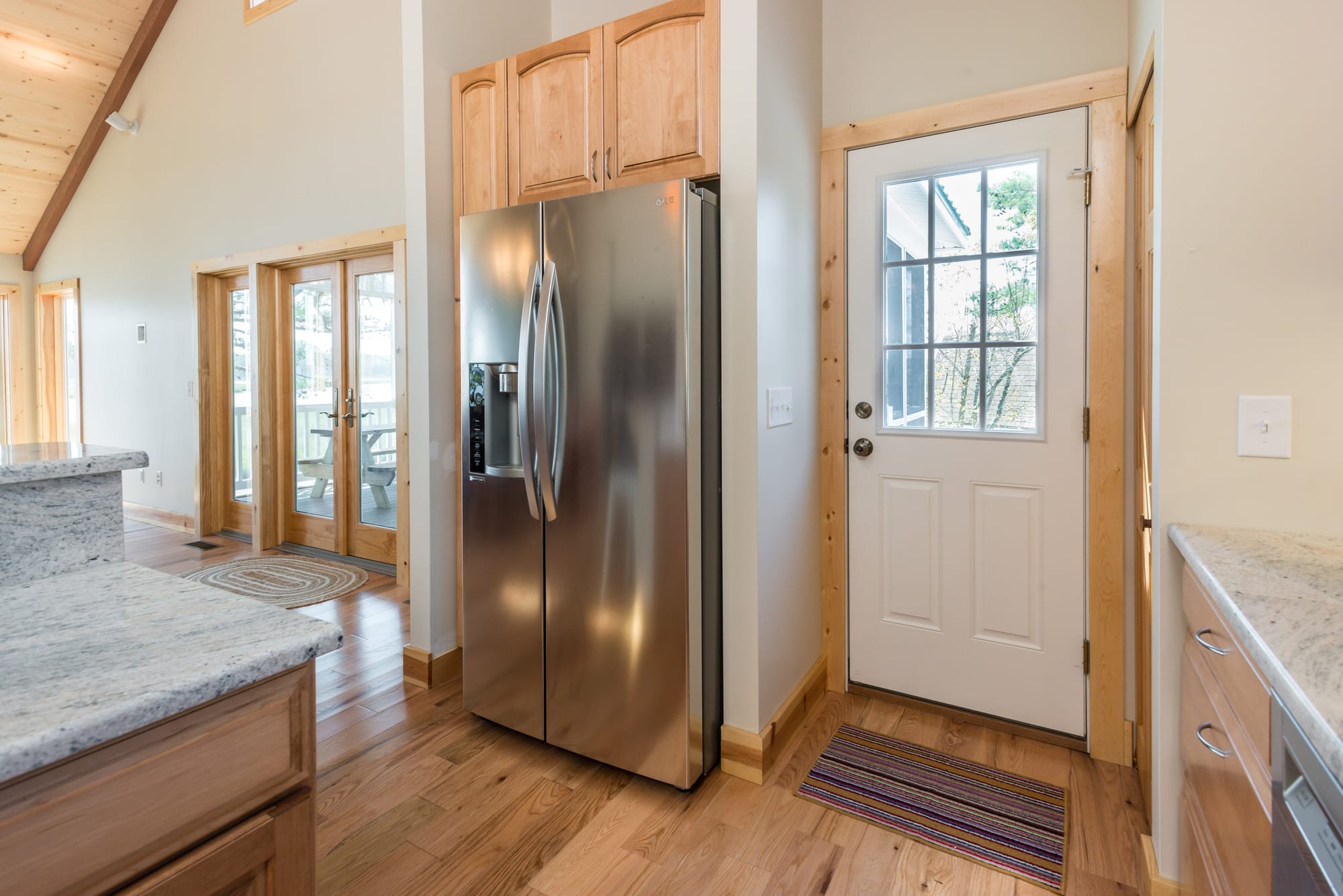 Kitchen with refrigerator and door.