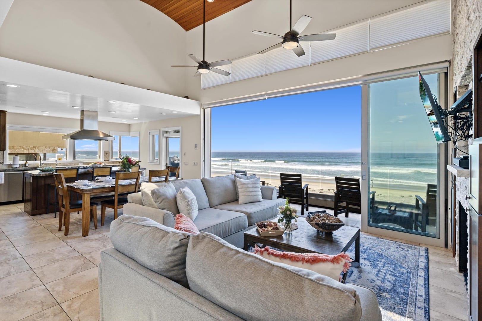 Oceanfront living room with large windows.