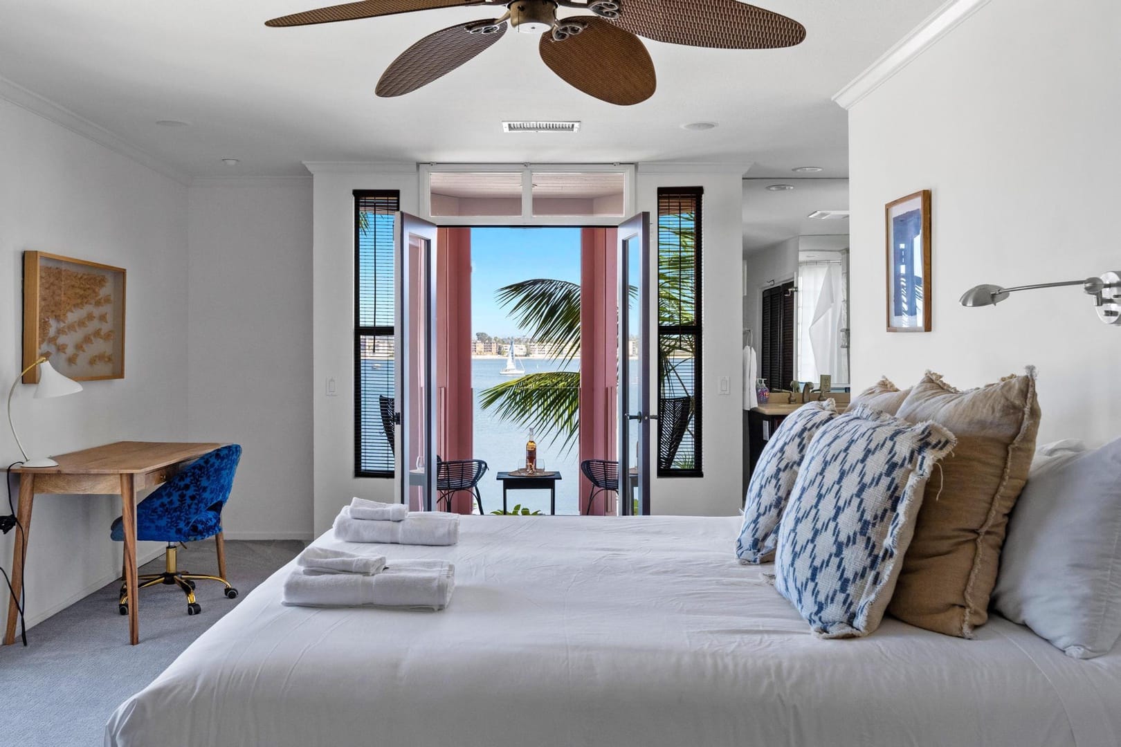 Bedroom with balcony and ocean view.