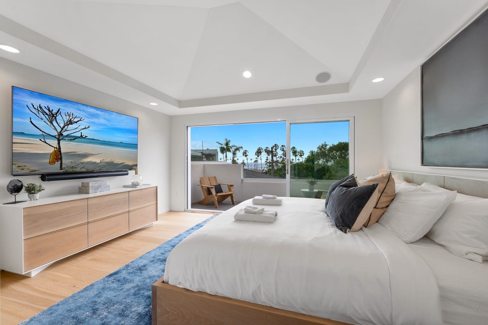 Modern bedroom with balcony view.