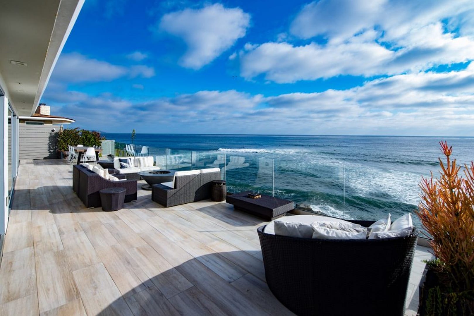 Oceanfront deck with outdoor furniture.