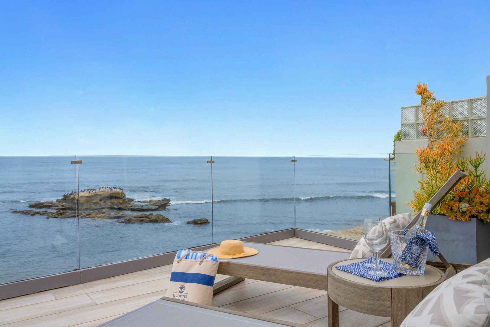 Ocean-facing patio with glass railing.