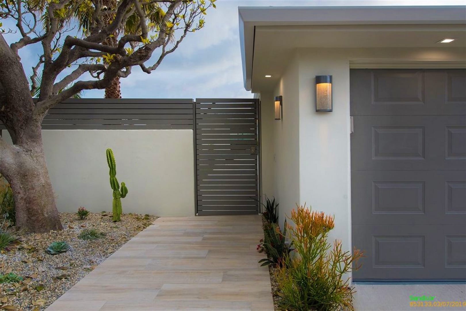 Modern entryway with cactus plant.