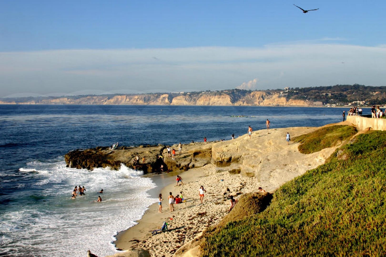 People enjoying a rocky beach.