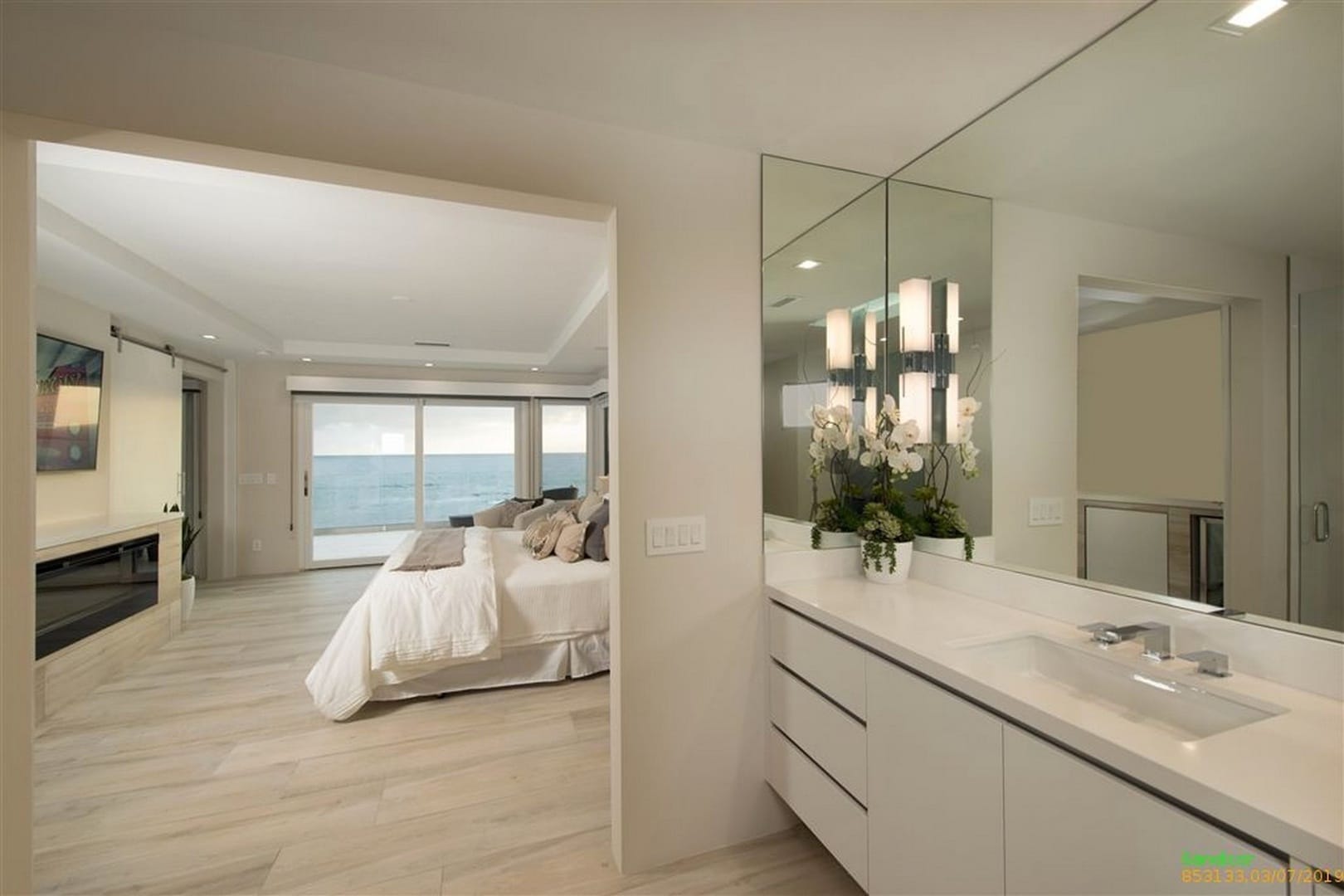 Bedroom with ocean view and vanity.