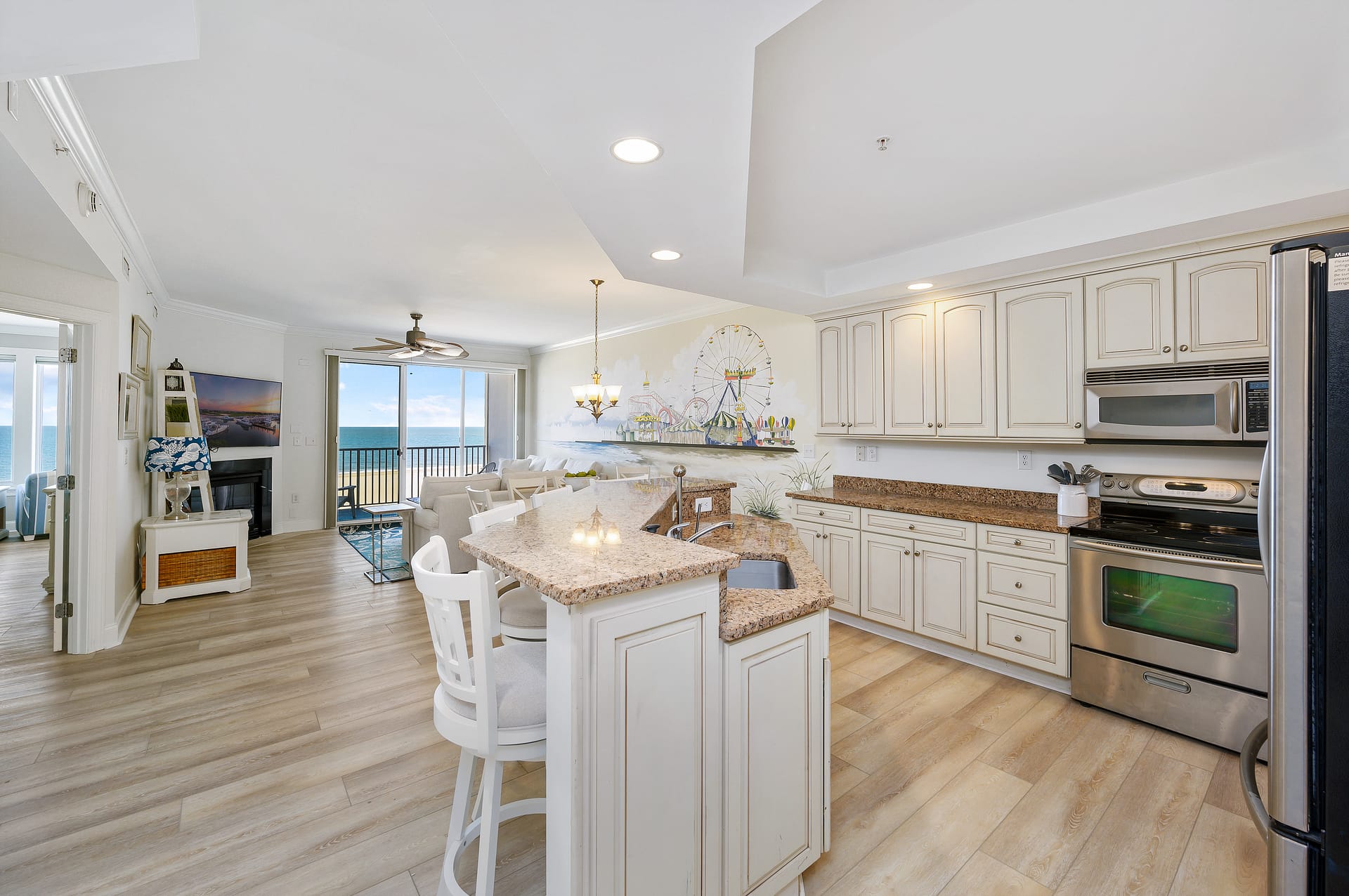 Modern kitchen-living space with ocean view.