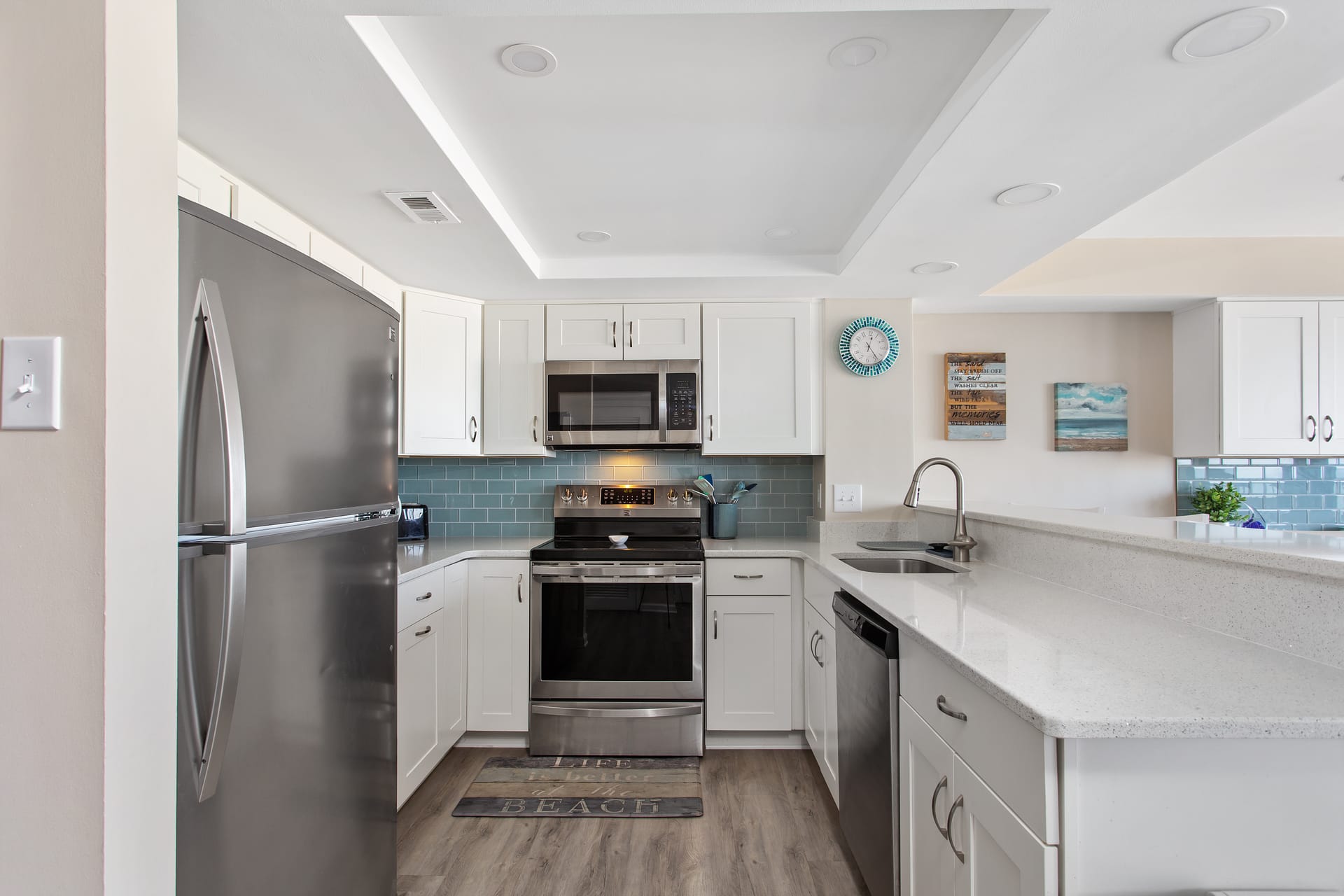 Modern kitchen with stainless steel appliances.