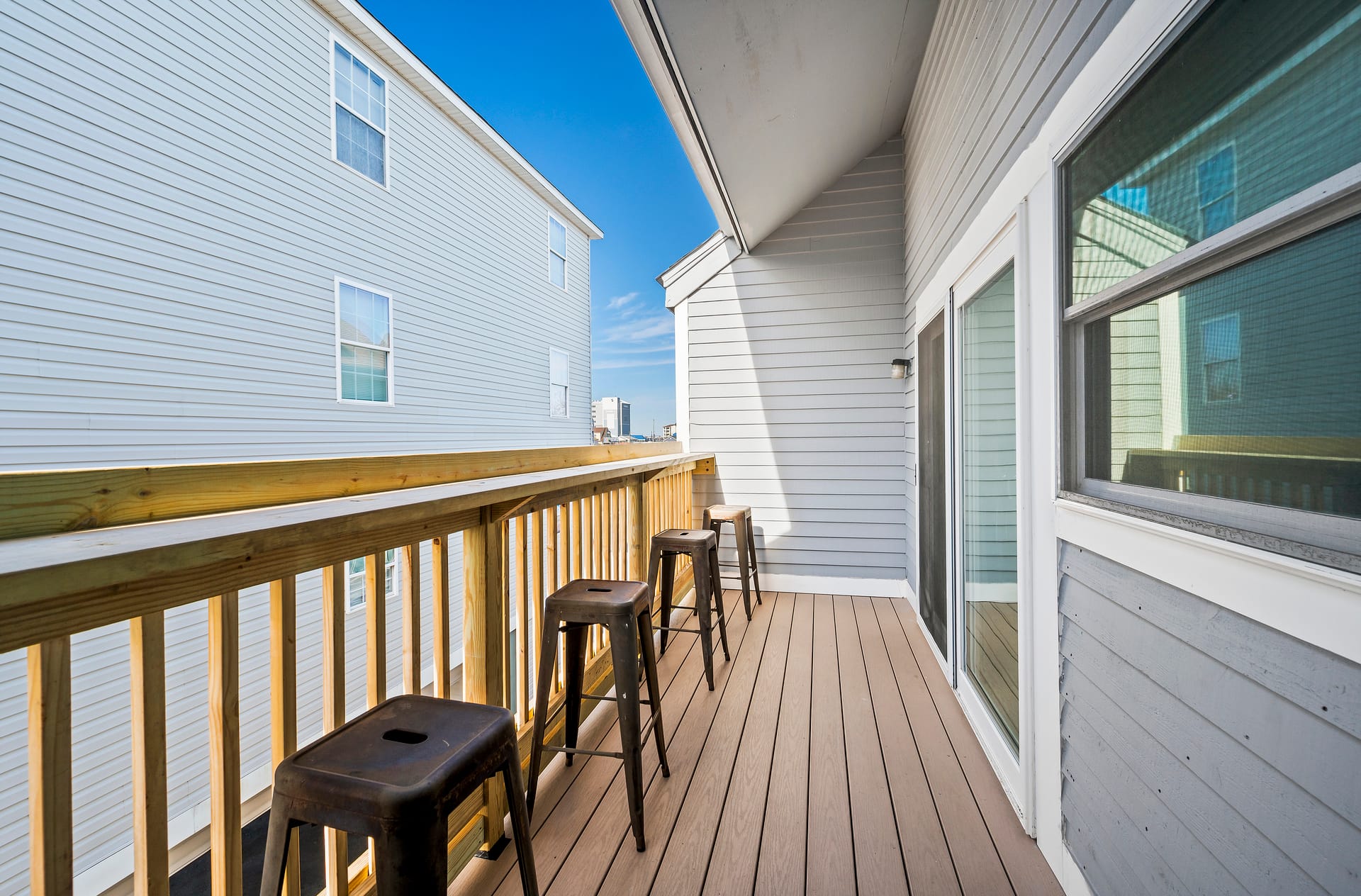 Narrow balcony with stools.