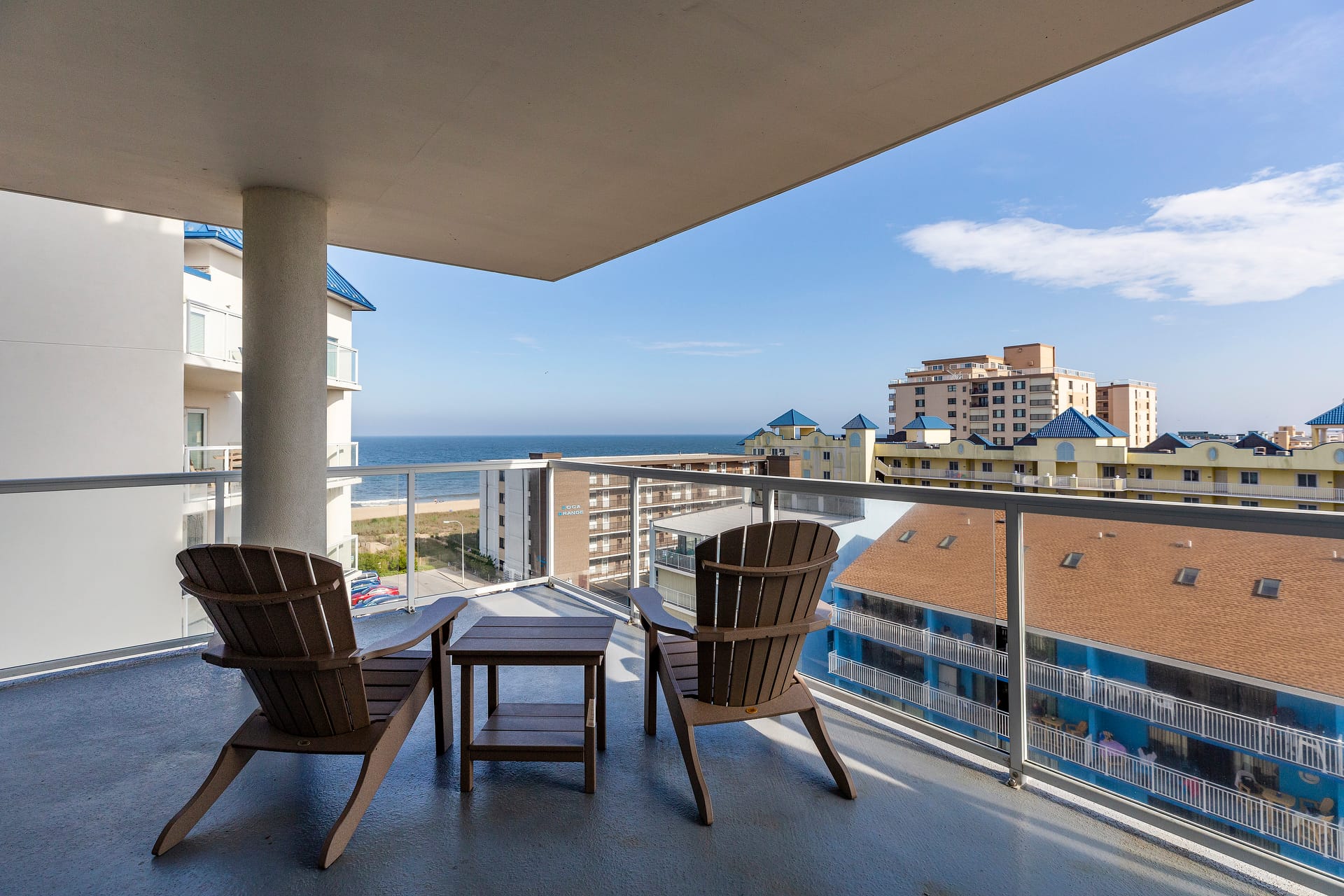 Balcony view of ocean and buildings.