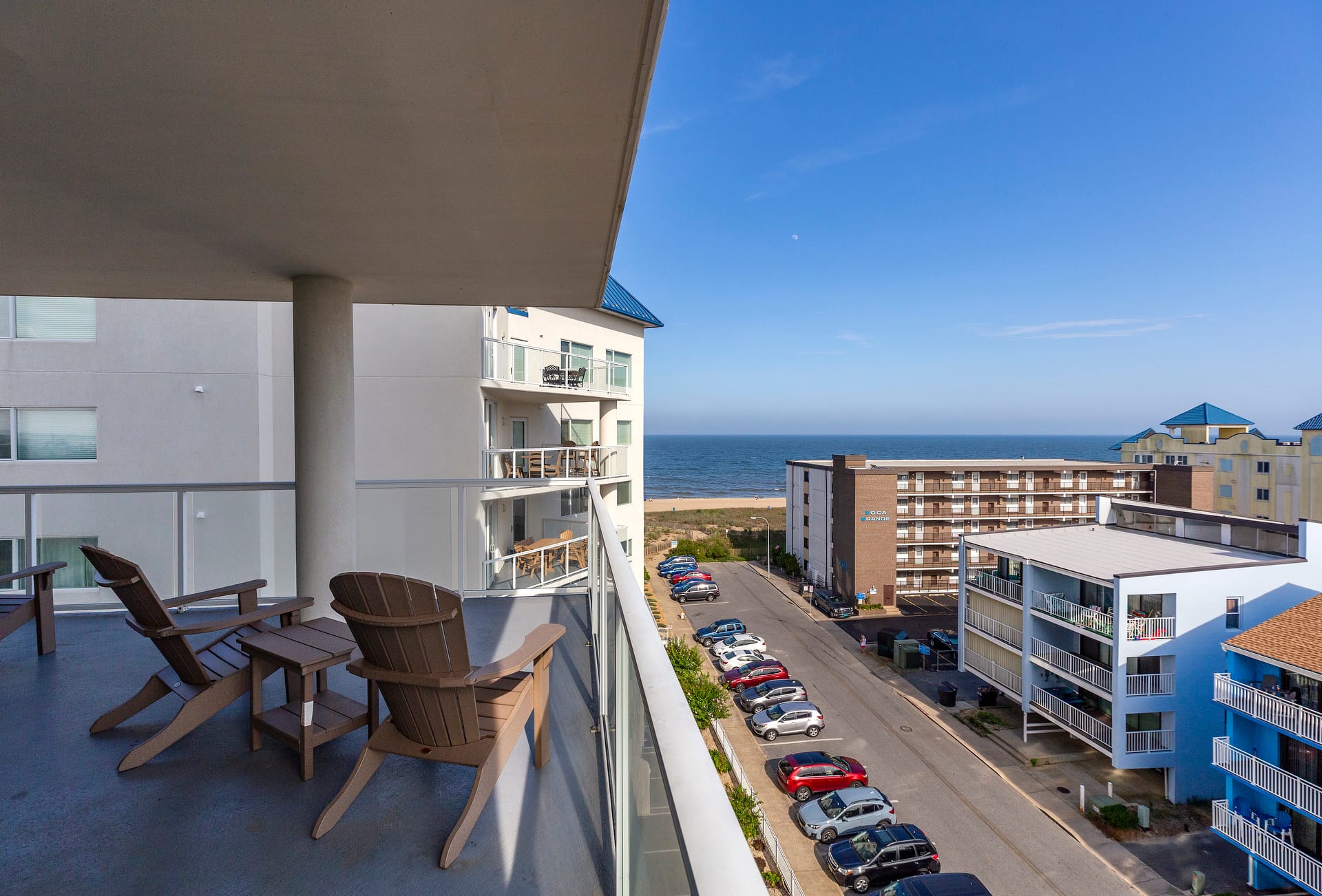 Balcony view of ocean and buildings.