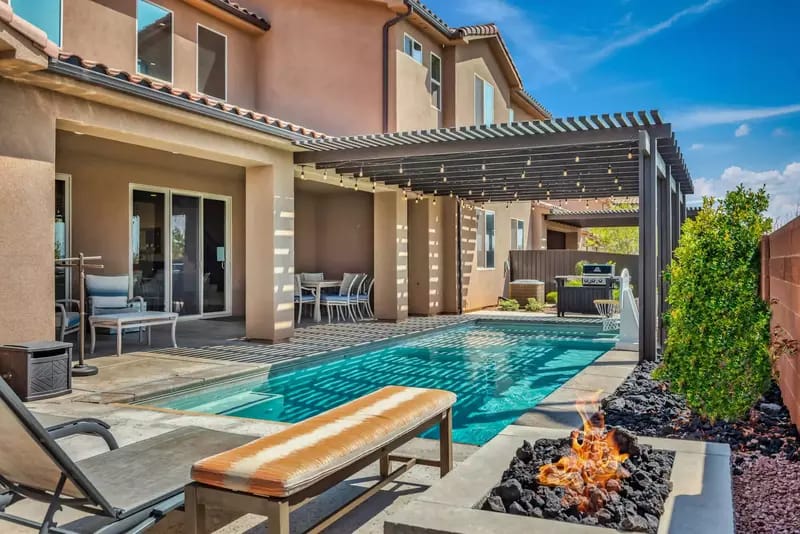 Backyard pool with covered patio.