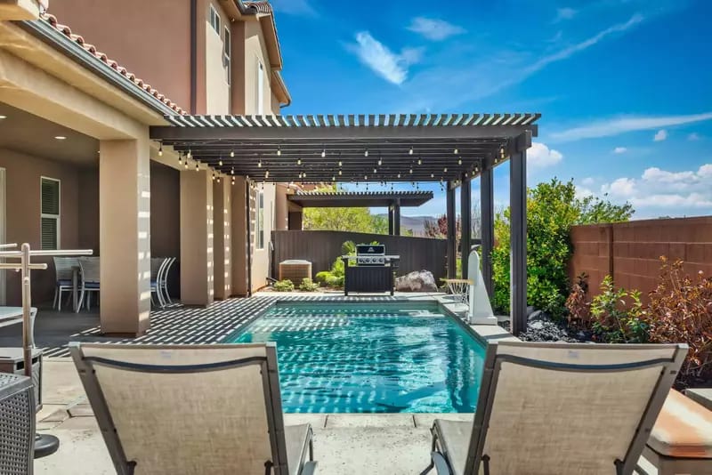 Backyard with pool and pergola.