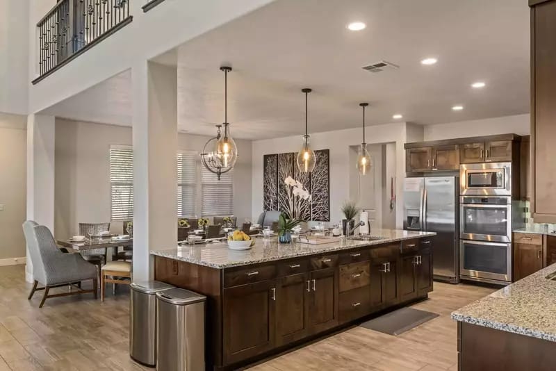 Modern kitchen with island, dining area.