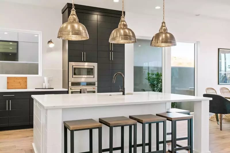 Modern kitchen with island and stools.