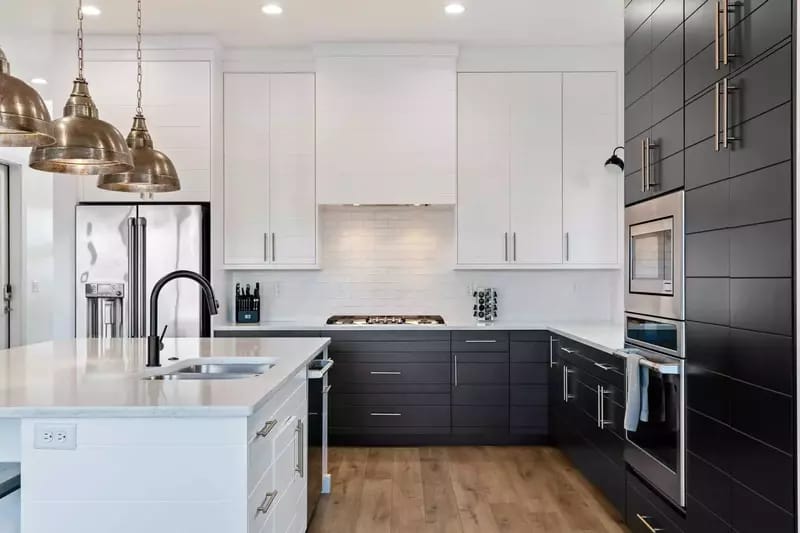 Modern kitchen with black-and-white cabinets.