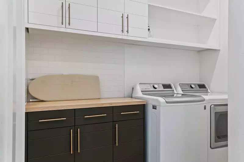 Modern laundry room with cabinets.