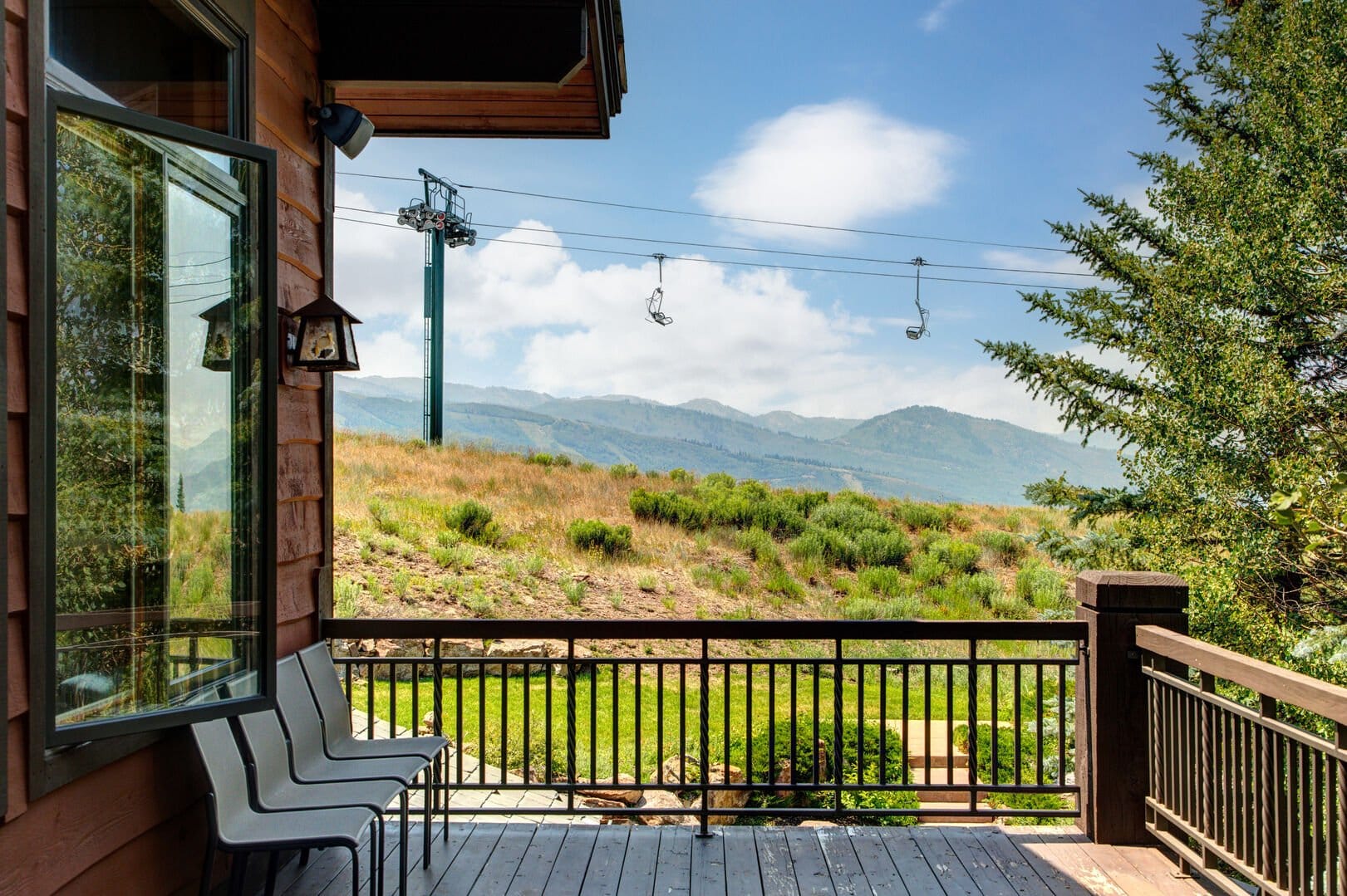 Mountain view from deck with chairs.