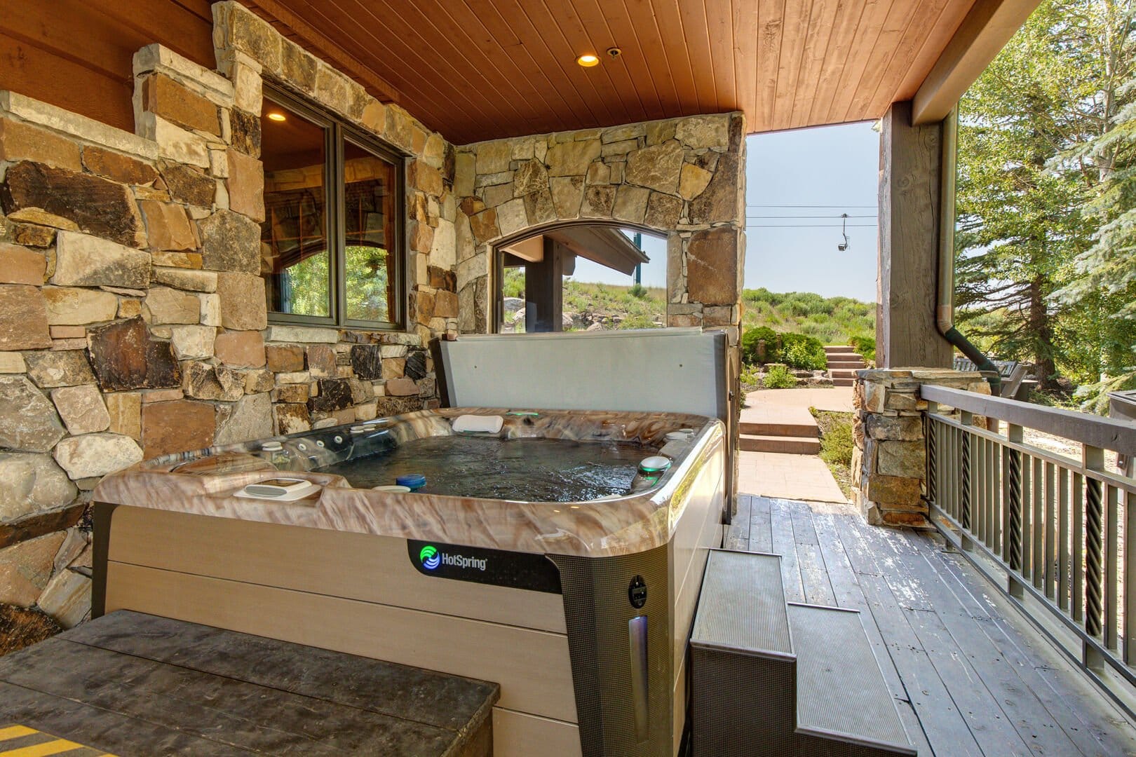 Covered patio with hot tub.