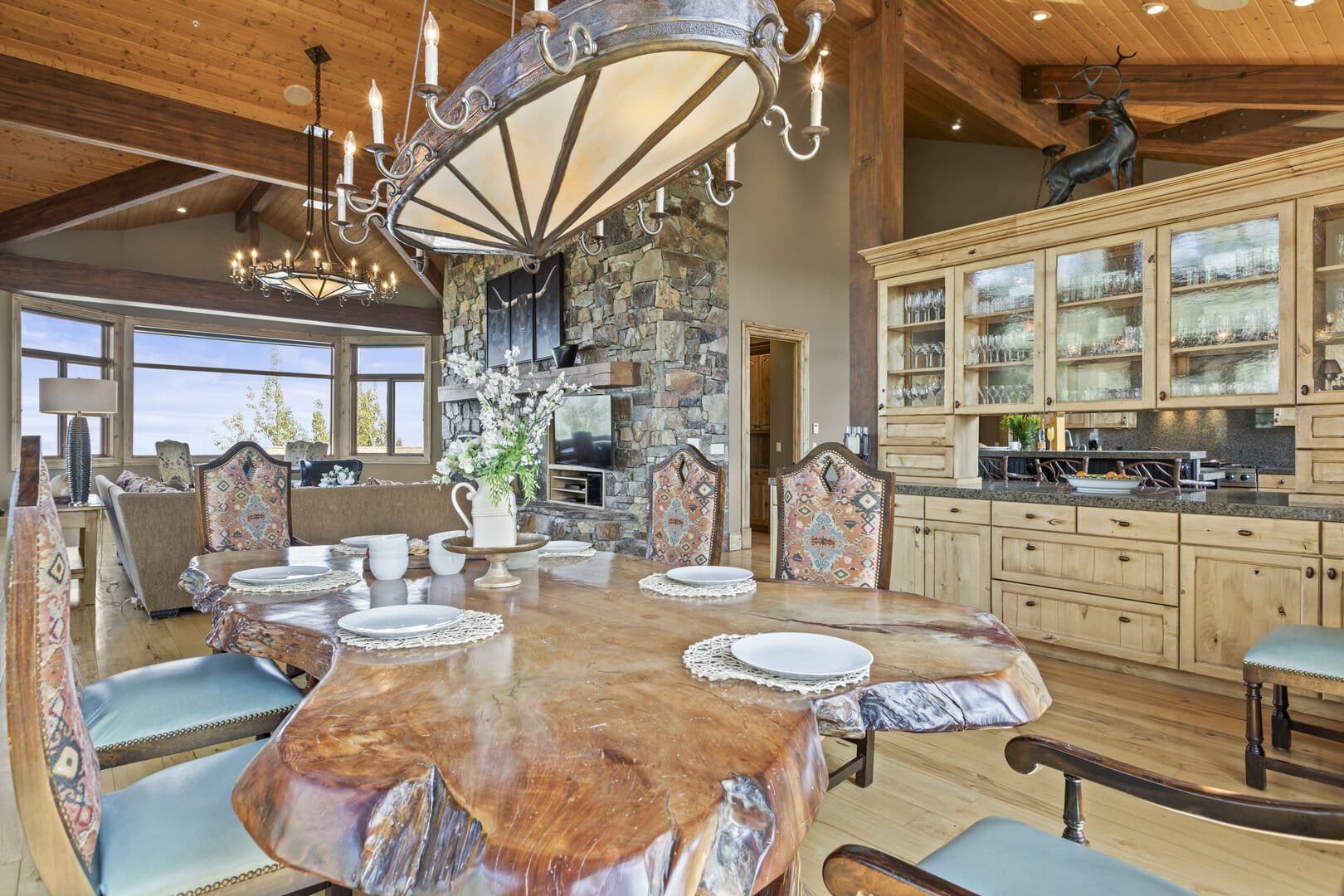 Rustic dining area with stone fireplace.