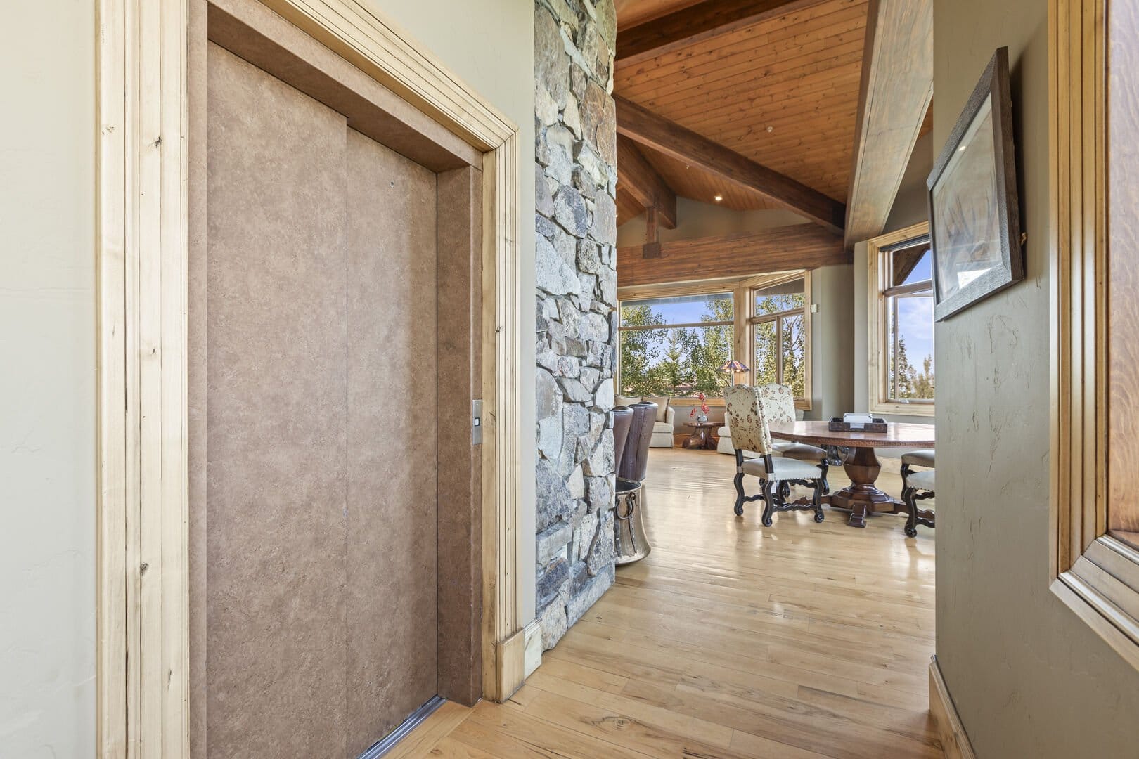 Elevator near stone wall, dining area.