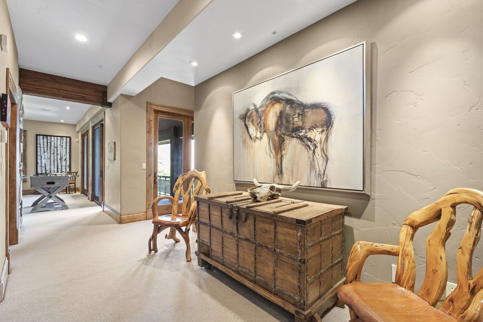 Hallway with rustic decor, artwork.