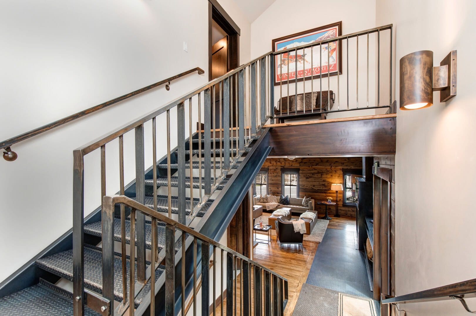 Staircase above rustic living room.