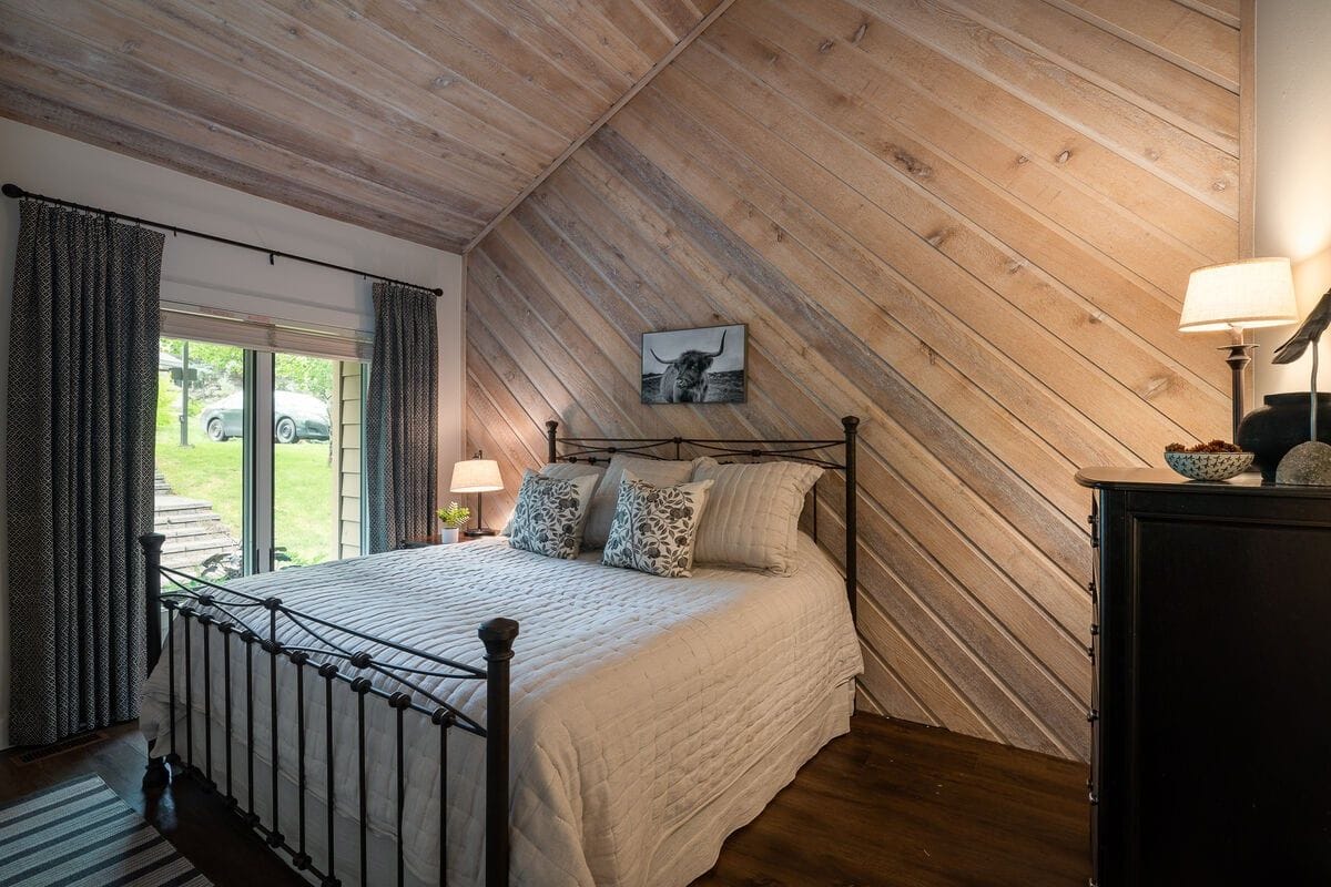 Cozy bedroom with wooden accent wall.